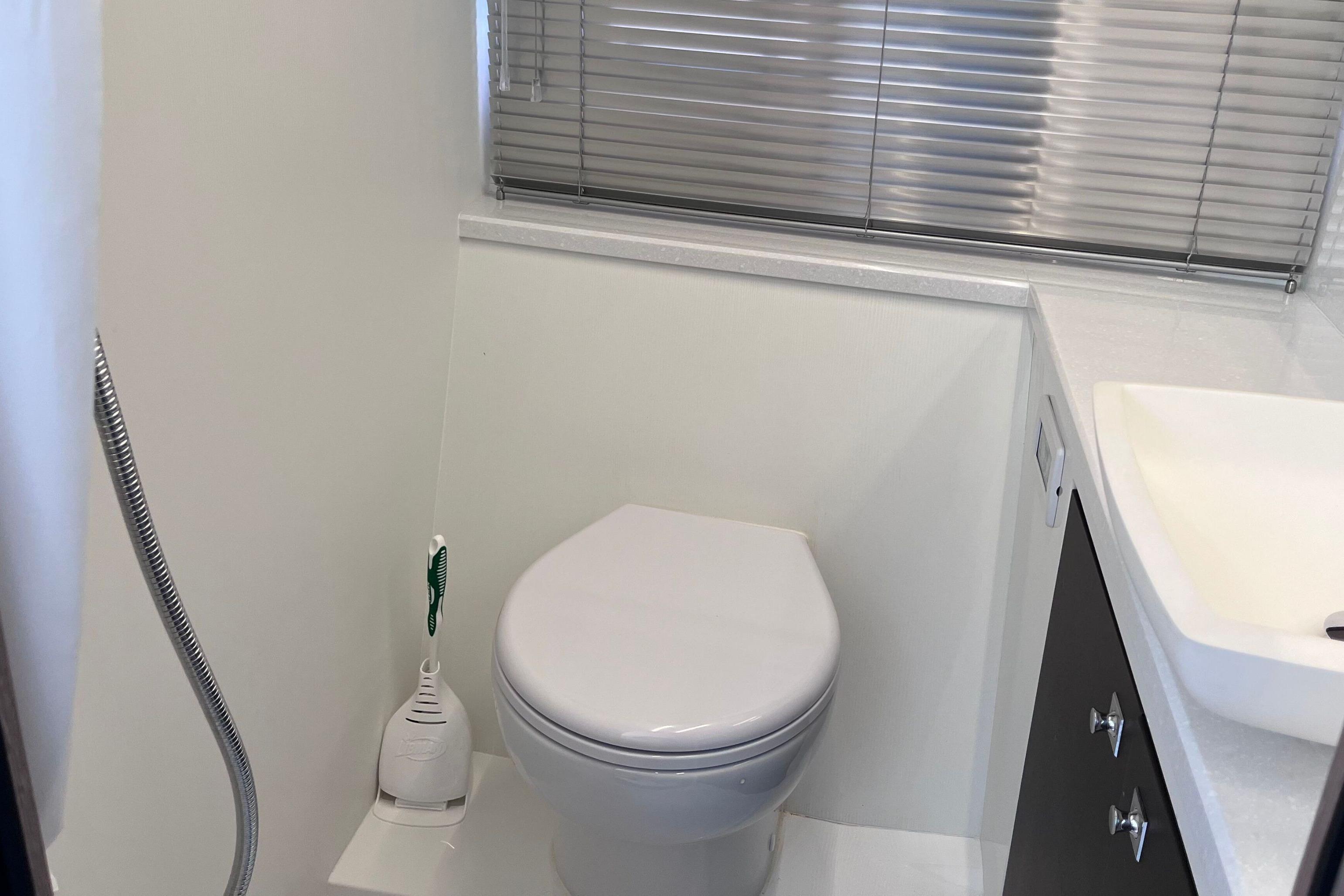 Modern bathroom in 2024 Galeon 425 HTS yacht with toilet and sink.