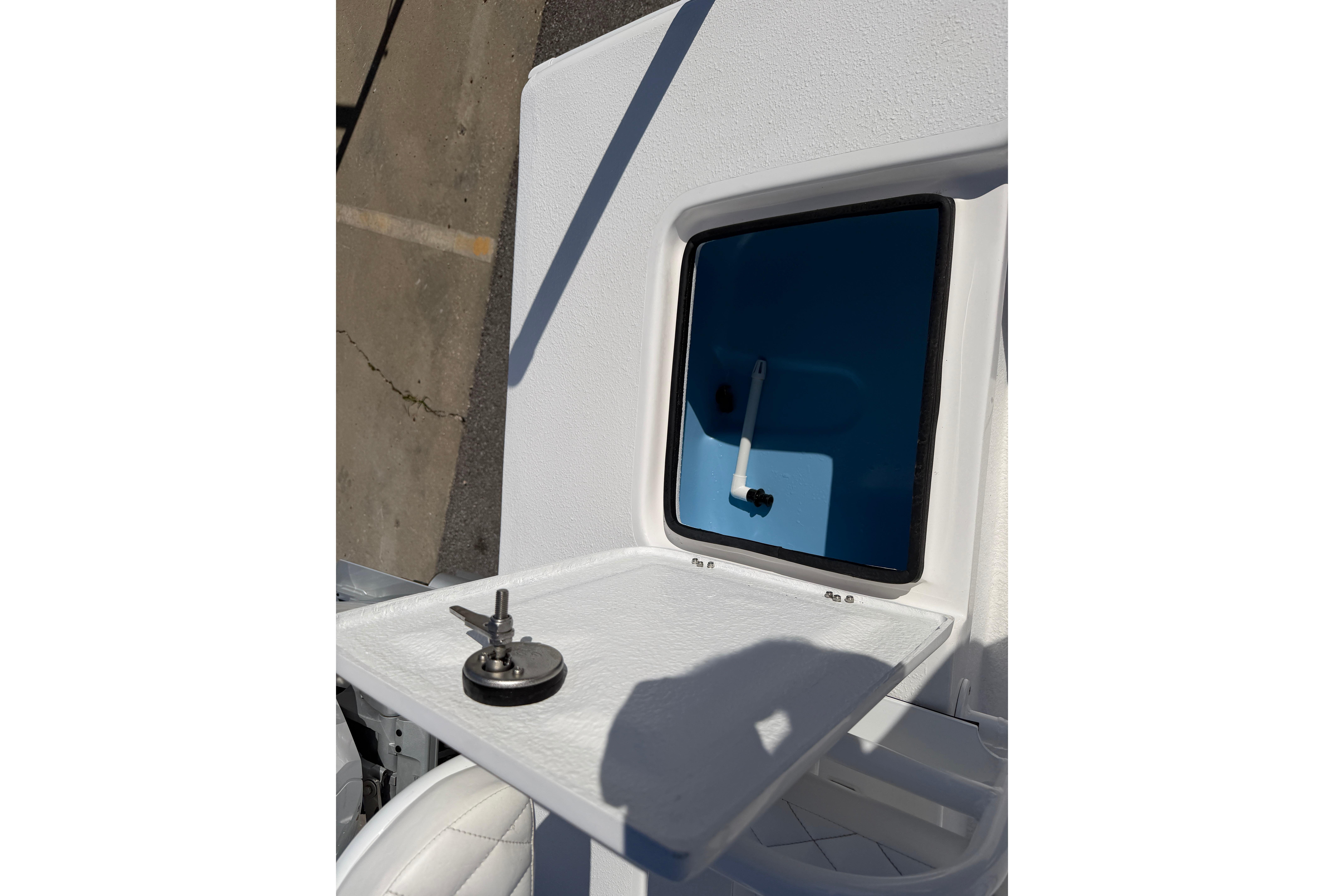 2026 Skuta 24 Cat boat hatch with key on white surface.