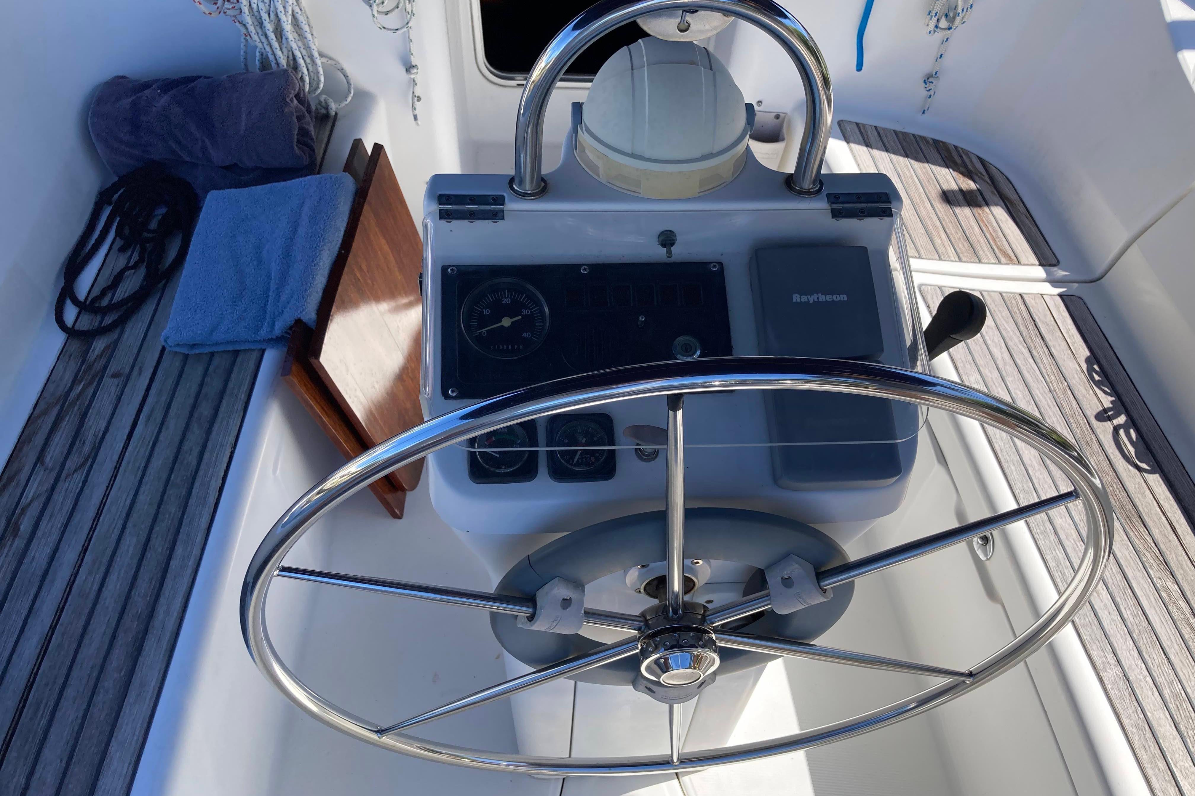 Steering wheel and controls of a 2000 Beneteau Oceanis 311 sailboat.