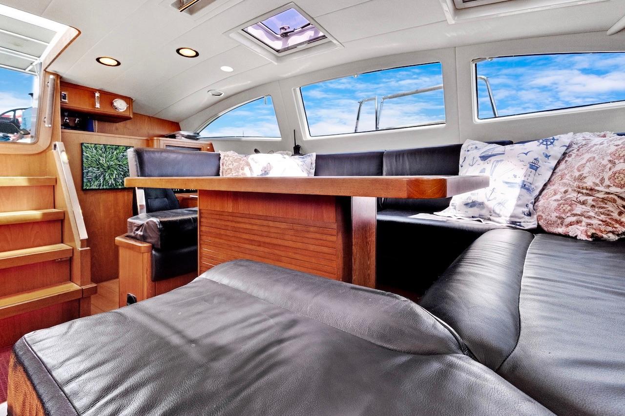 Luxurious interior of 2011 Southerly 57 RS yacht with leather seating and wooden accents.