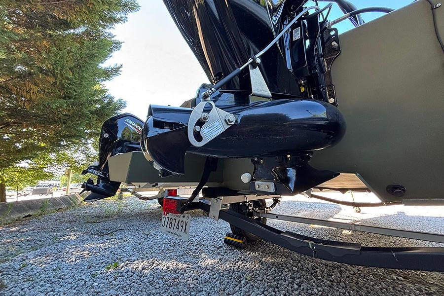 2022 Lowe Roughneck 1660 boat motor and trailer on gravel surface.