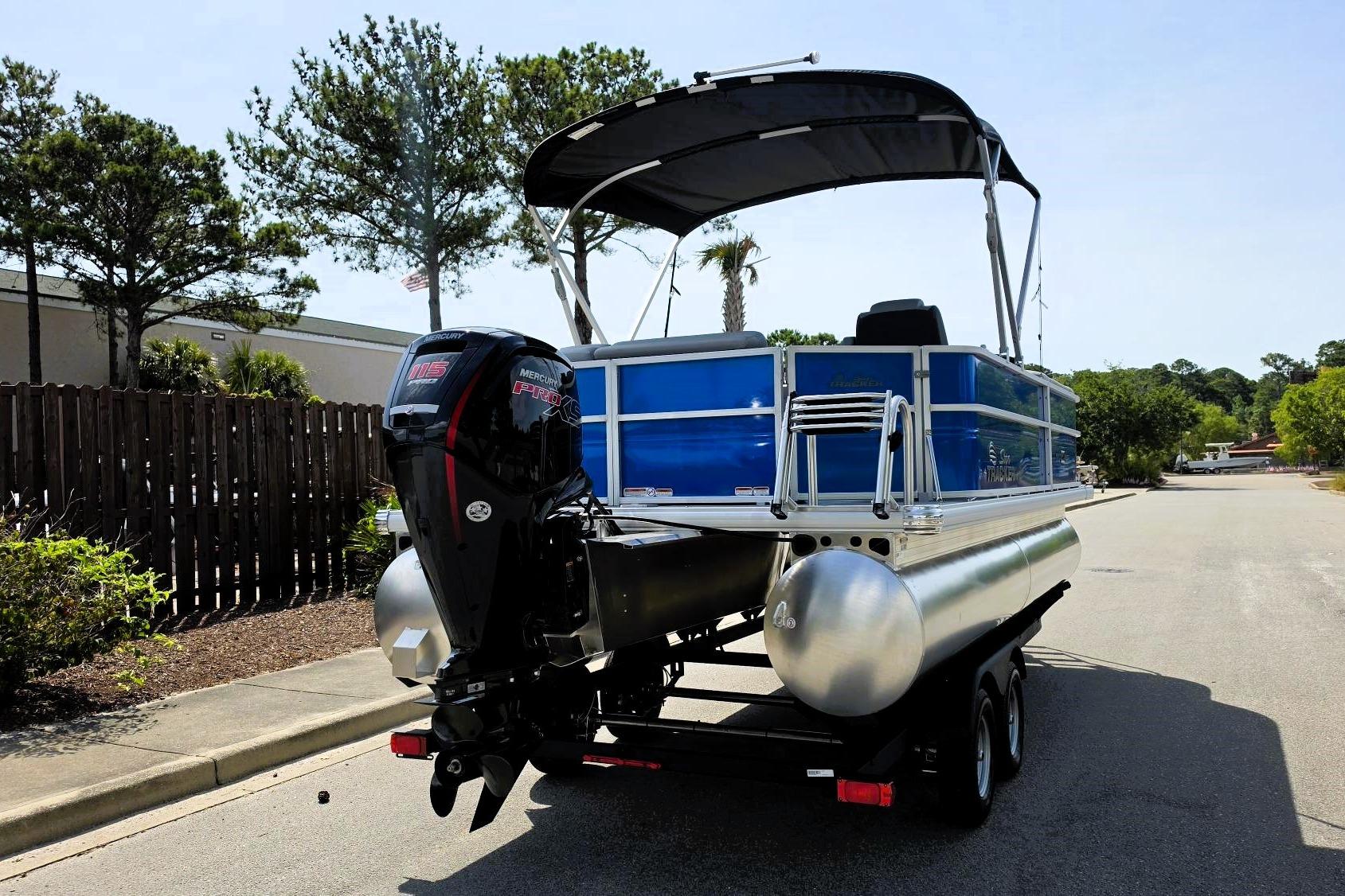 2026 Sun Tracker Party Barge 20 DLX pontoon boat with Mercury engine on trailer.