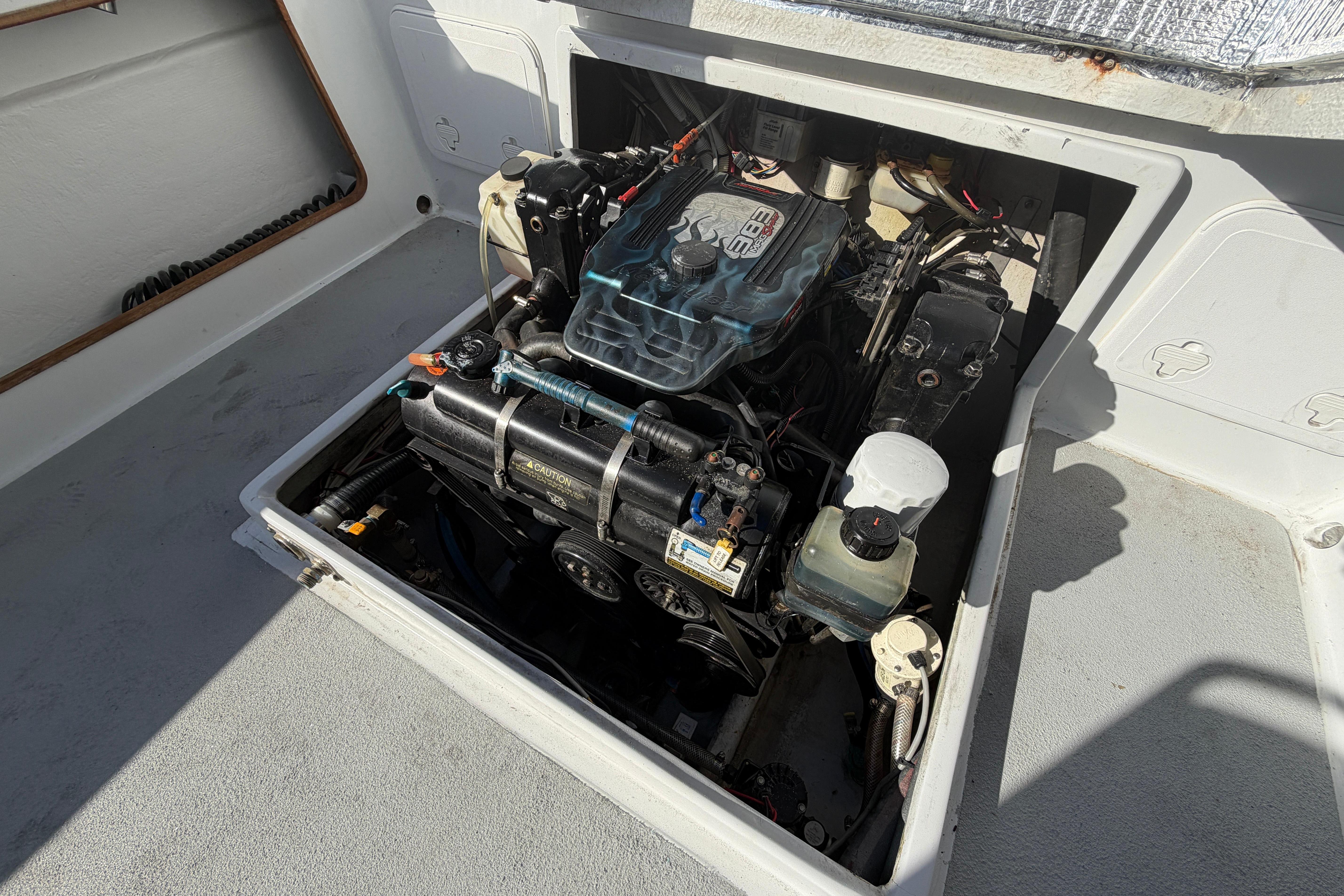 Engine compartment of a 1986 Radon 21 Sport boat, showcasing detailed mechanical components.