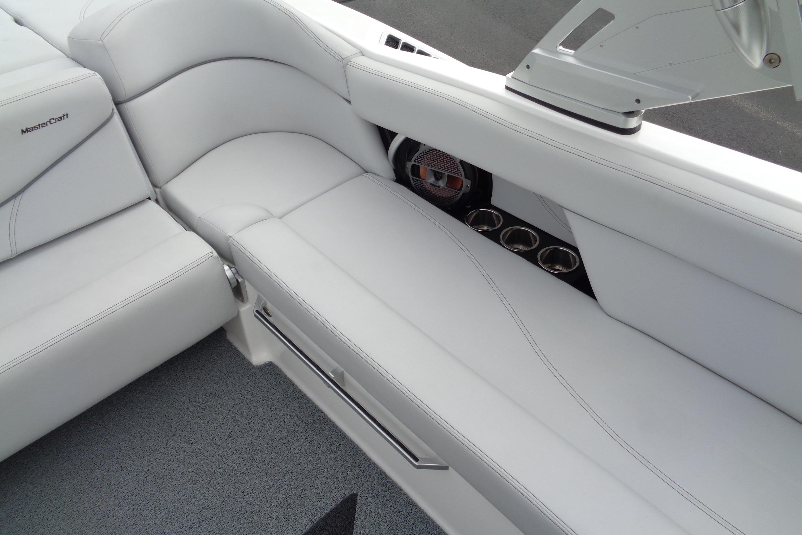 2020 MasterCraft XT23 boat interior with white seating and cup holders.