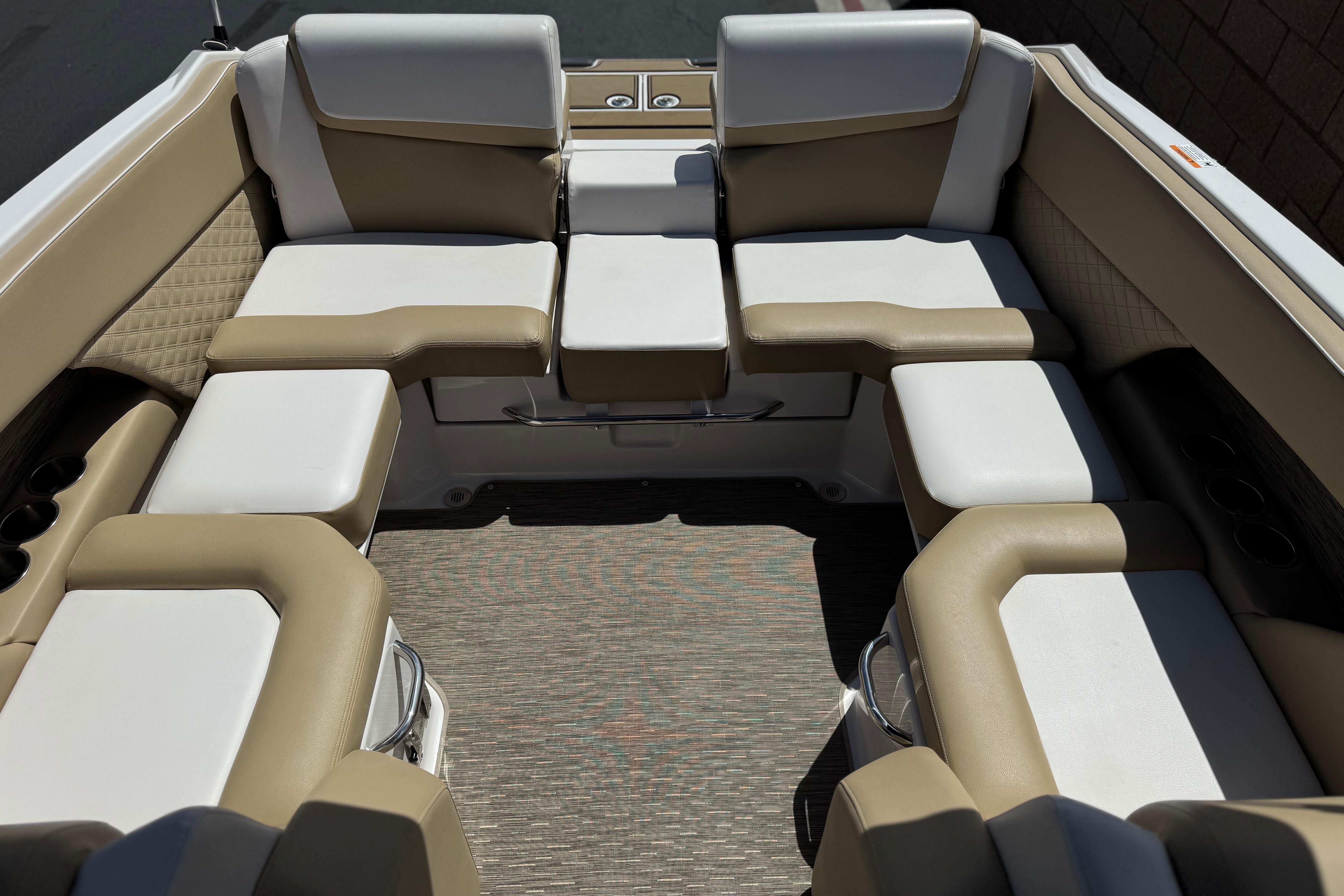 Interior seating of 2017 Scarab 255 H.O. Platinum boat, featuring beige and white upholstery.