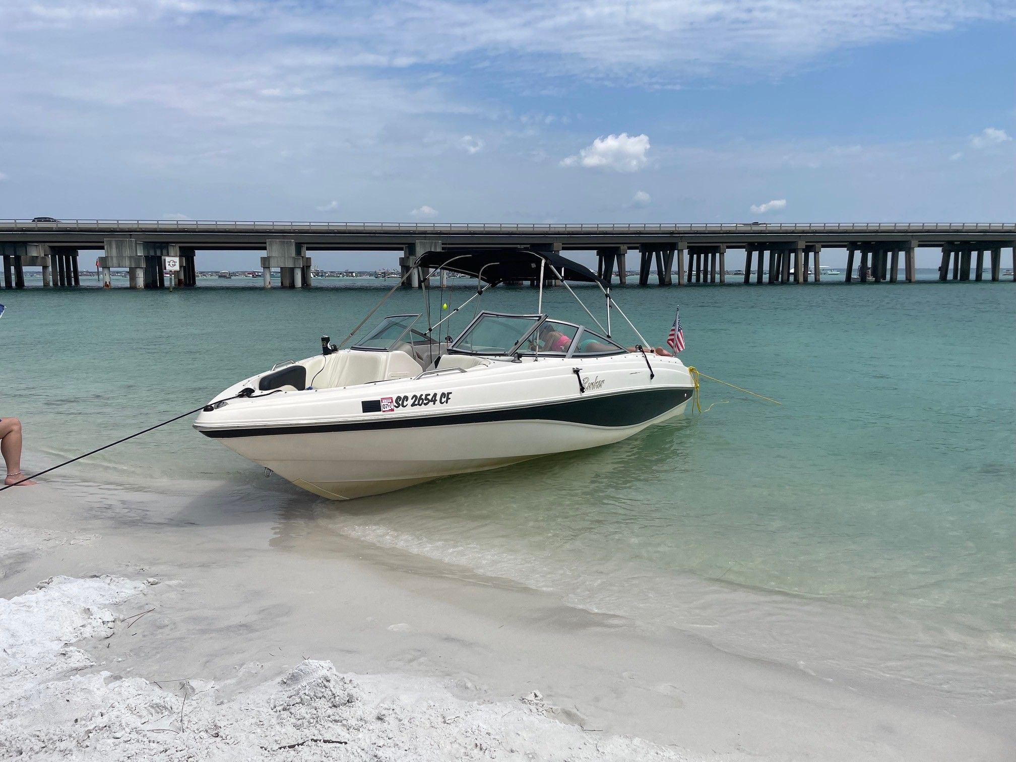 2002 Rinker 212 Captiva Bowrider on beach near bridge.