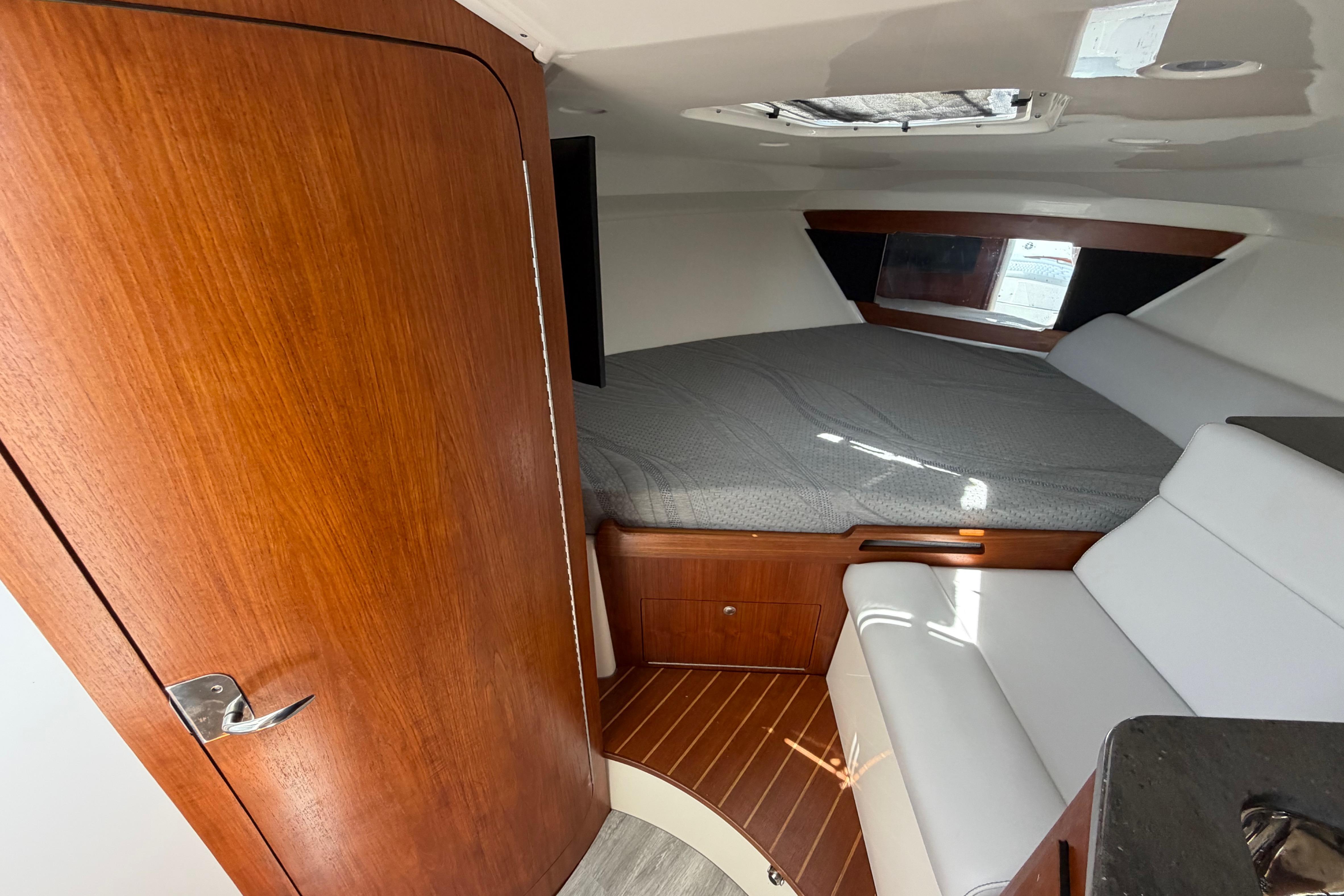 Interior cabin of 2009 Everglades 350LX boat with bed and seating area.