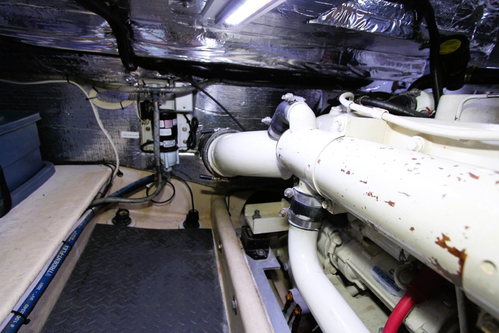 Engine room of a 2002 Nordic Tug 37, featuring pipes and mechanical components.