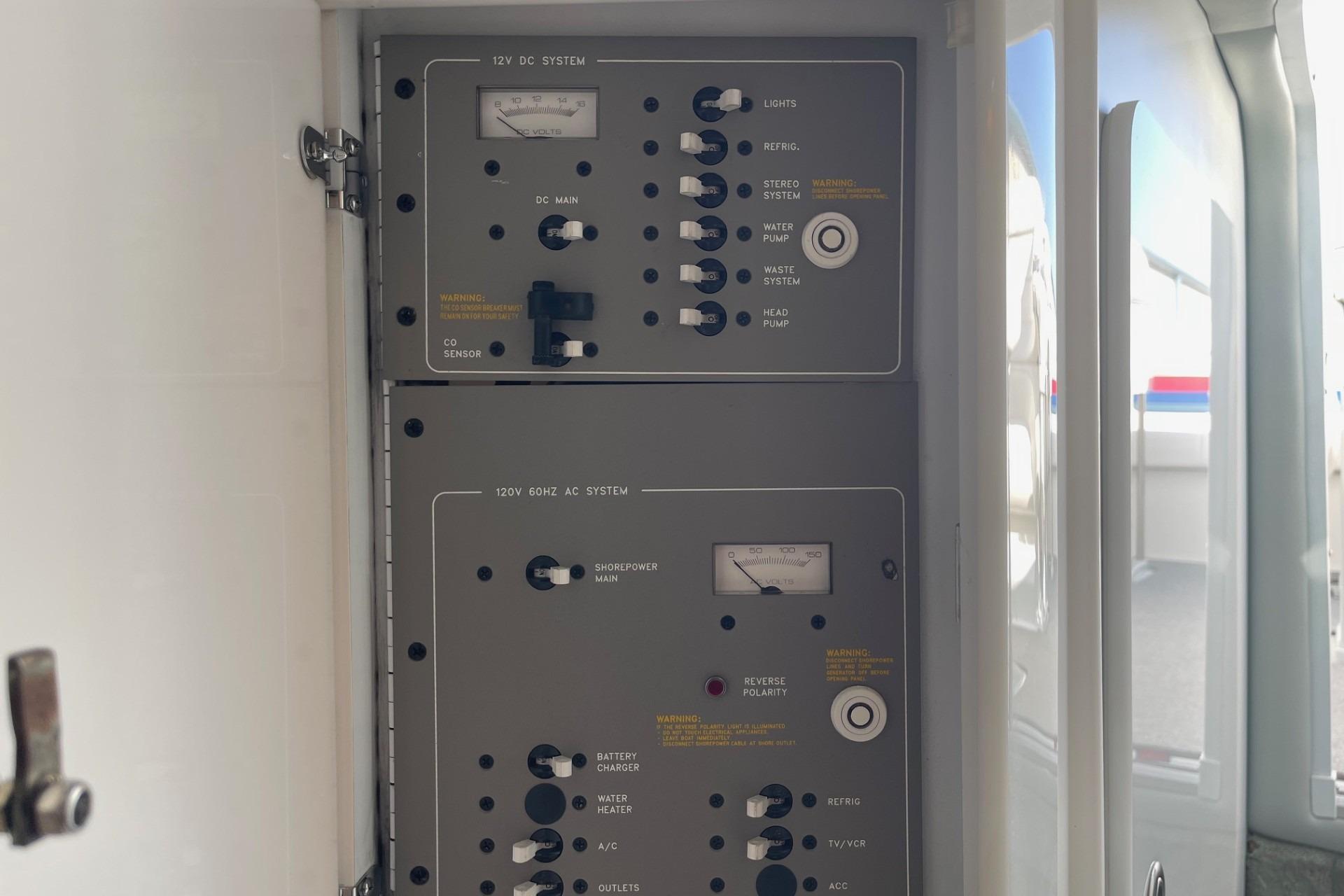 Control panel of a 2004 Formula 382 FASTech boat, featuring 12V DC and 120V AC systems.