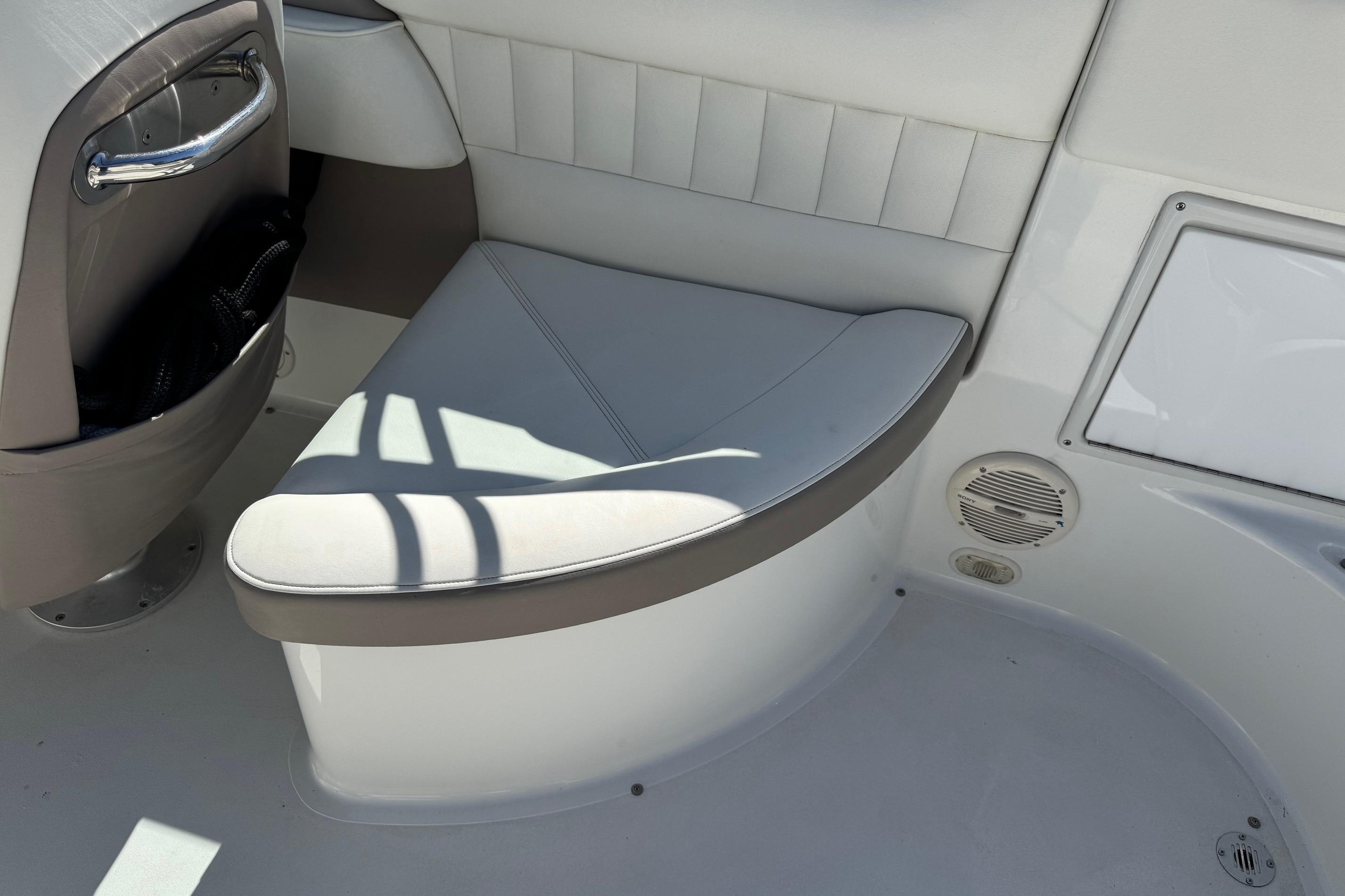 Interior seating of a 2005 Cobalt 240 boat, featuring white and gray upholstery.