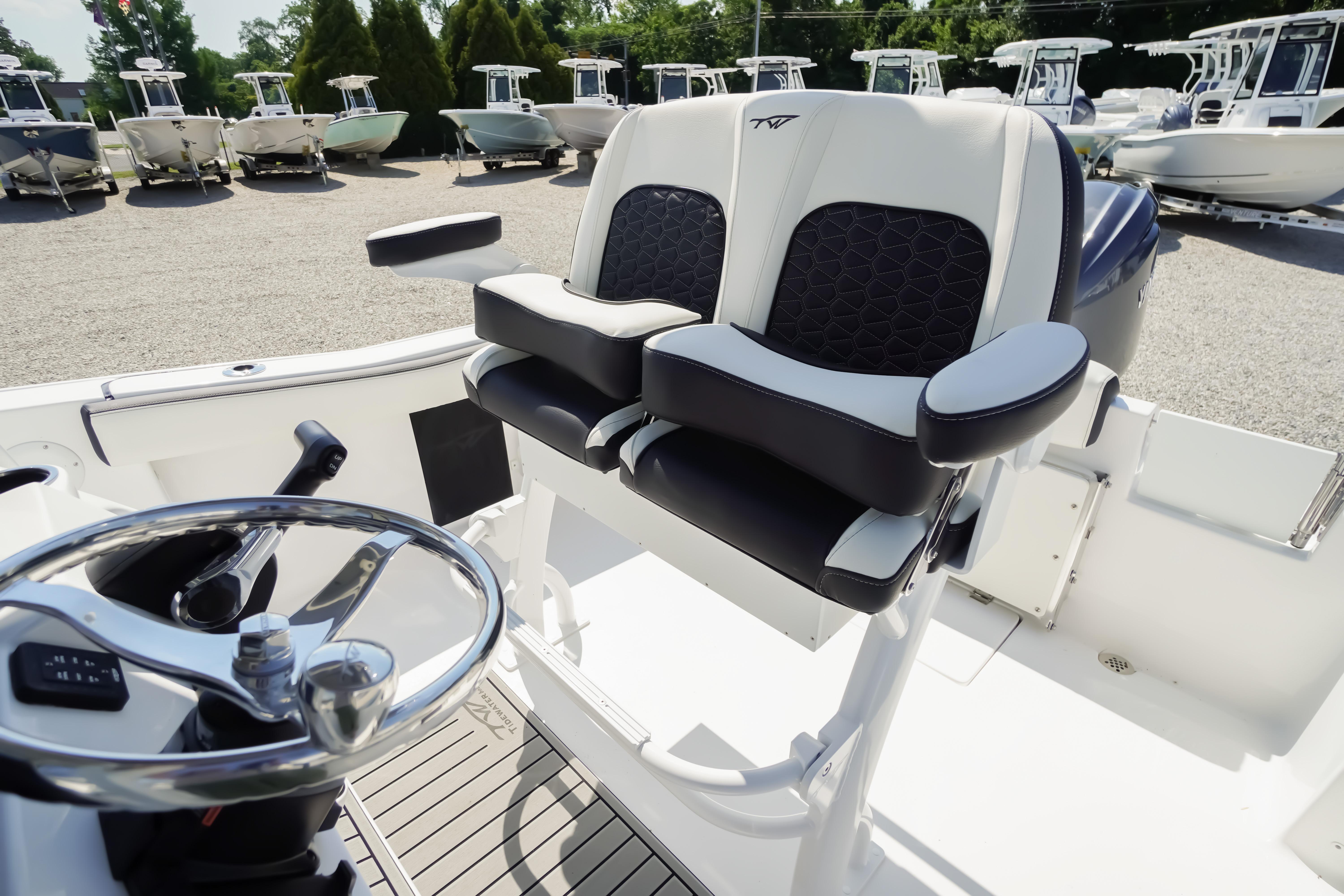 2026 Tidewater 220 CC Adventure boat interior with dual seats and steering wheel.