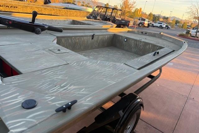 2025 Tracker Grizzly 1654 T Sportsman boat on trailer, outdoor setting.