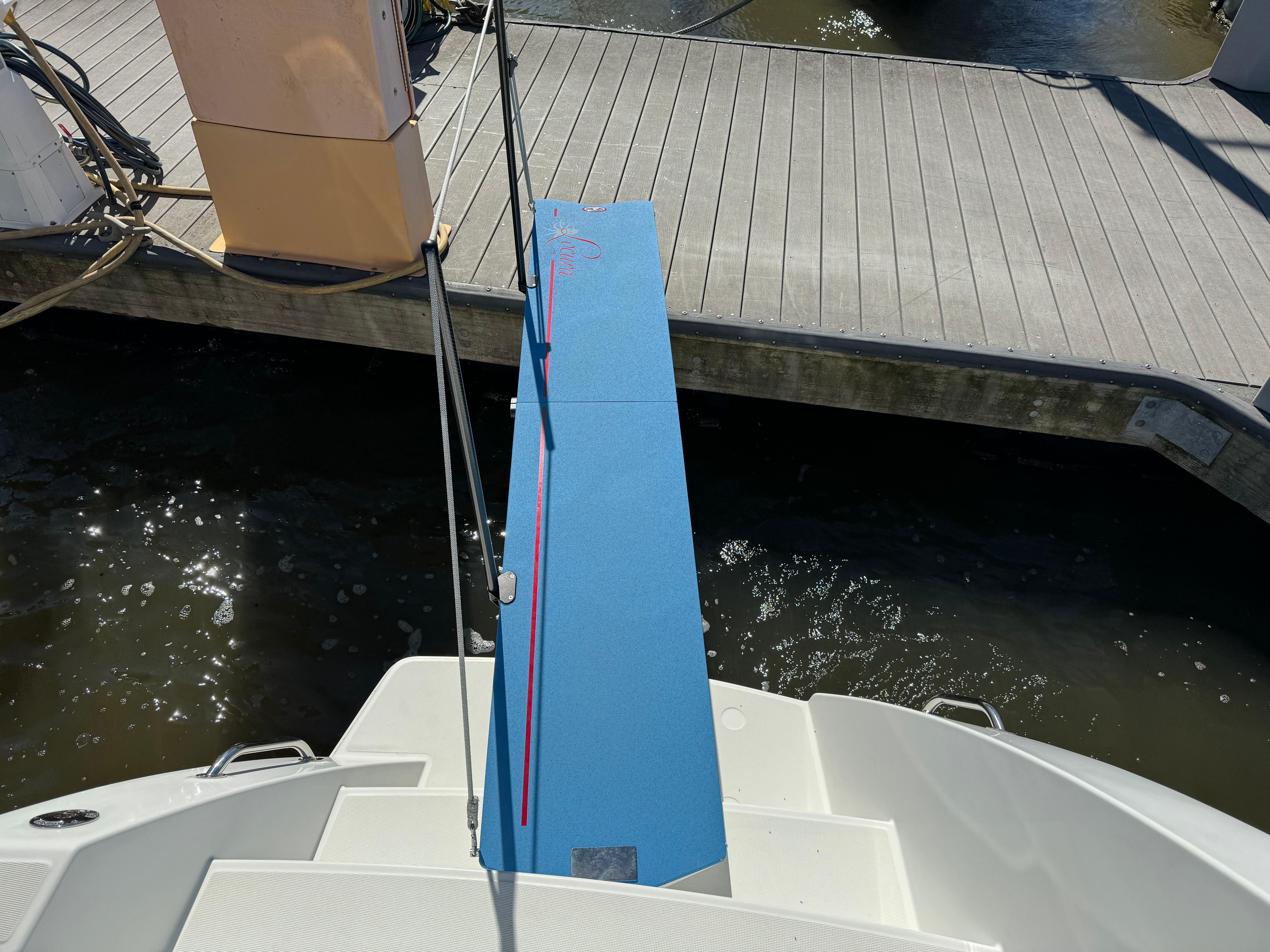 Boarding ramp of a 2016 Lagoon 450 catamaran at a dock.