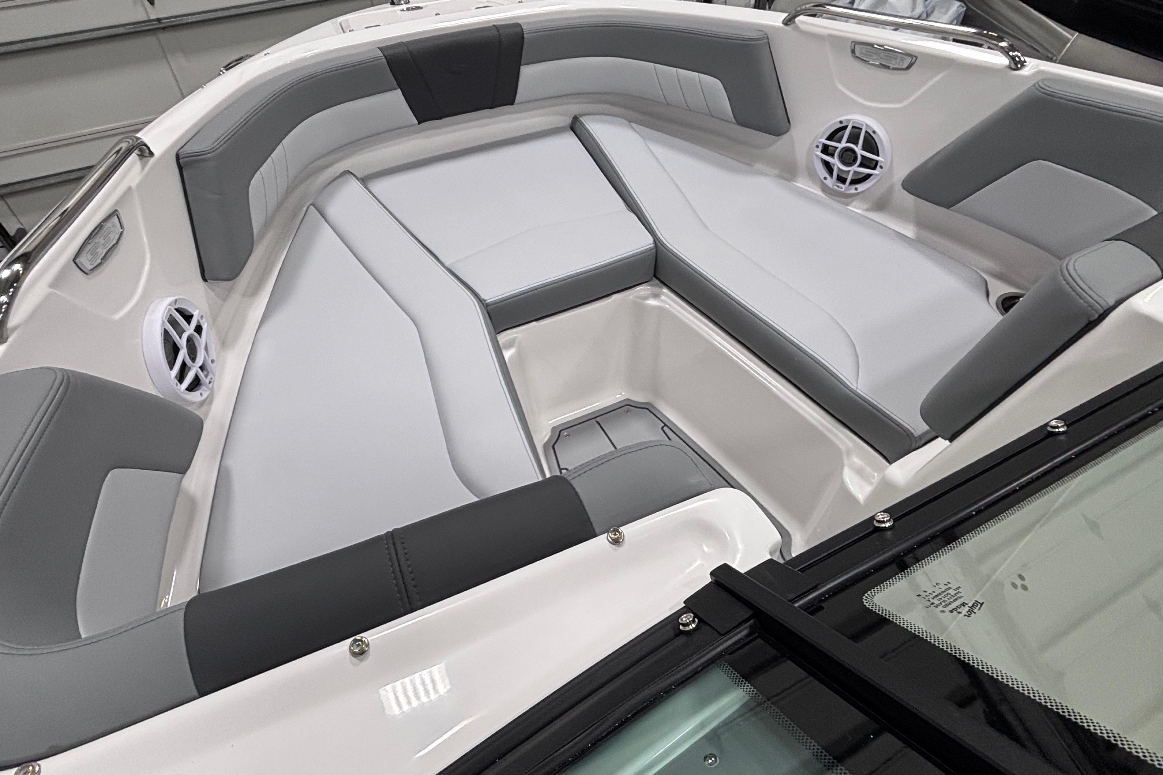 2026 Chaparral 21 SSi boat interior with gray and white seating, featuring built-in speakers.