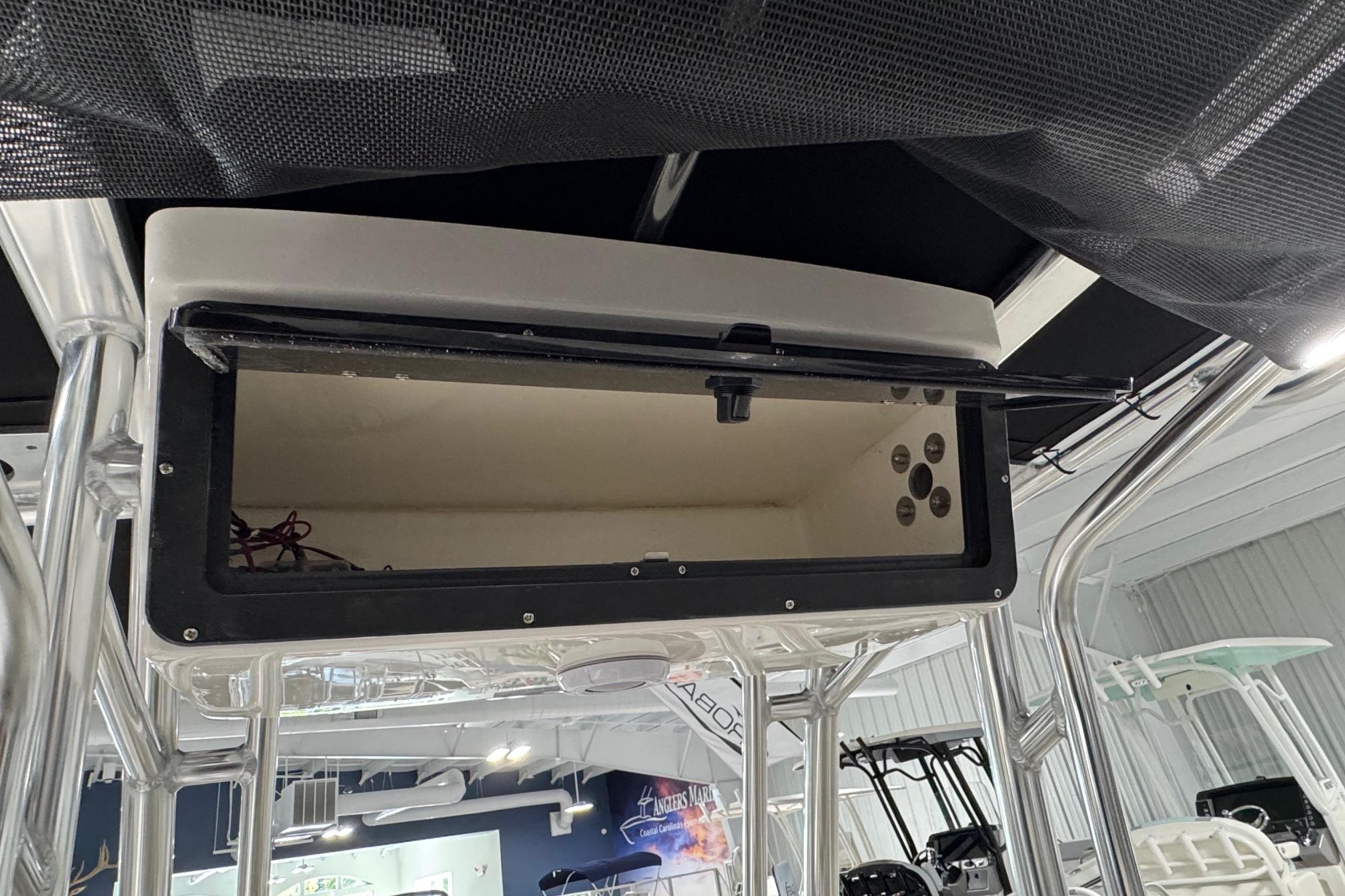 Open storage compartment on 2026 Key West 203 FS boat, showcasing interior details.