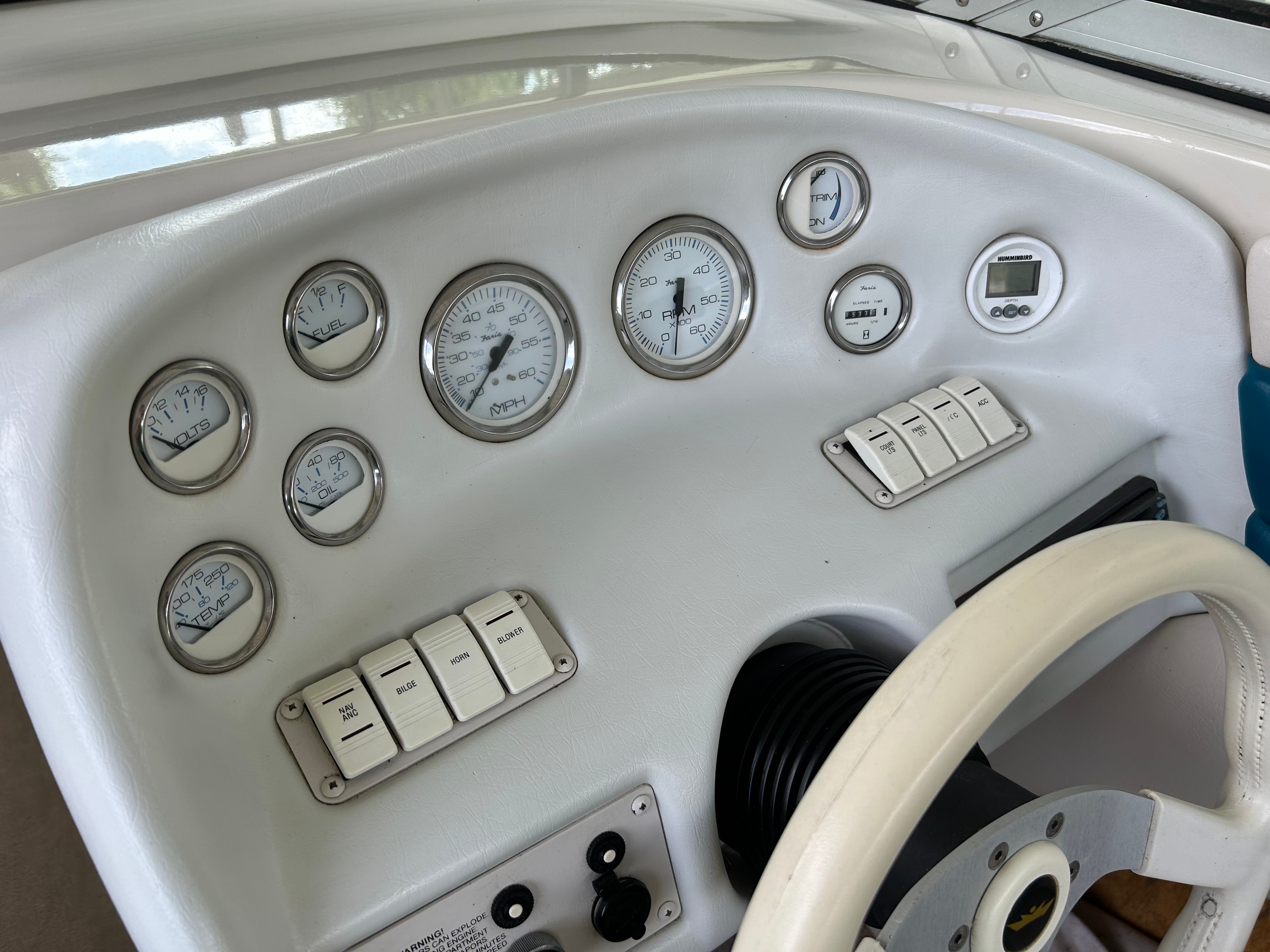 Dashboard of a 1995 Crownline 266 BR boat with gauges.