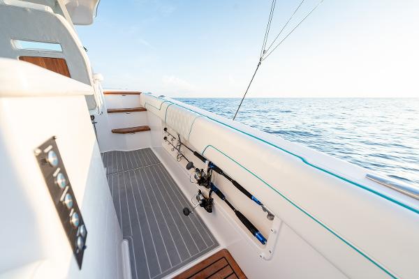 Manufacturer Provided Image: 2026 Regal 38 SAV boat deck with fishing rods, ocean view, and sleek design.