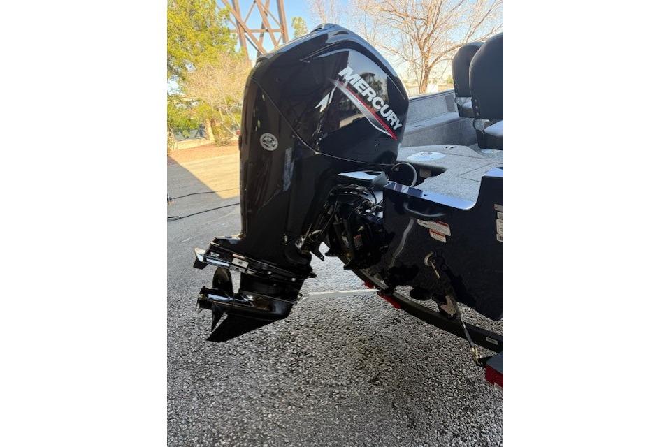 2026 Tracker Pro Guide V-16 SC with Mercury outboard motor, parked outdoors.
