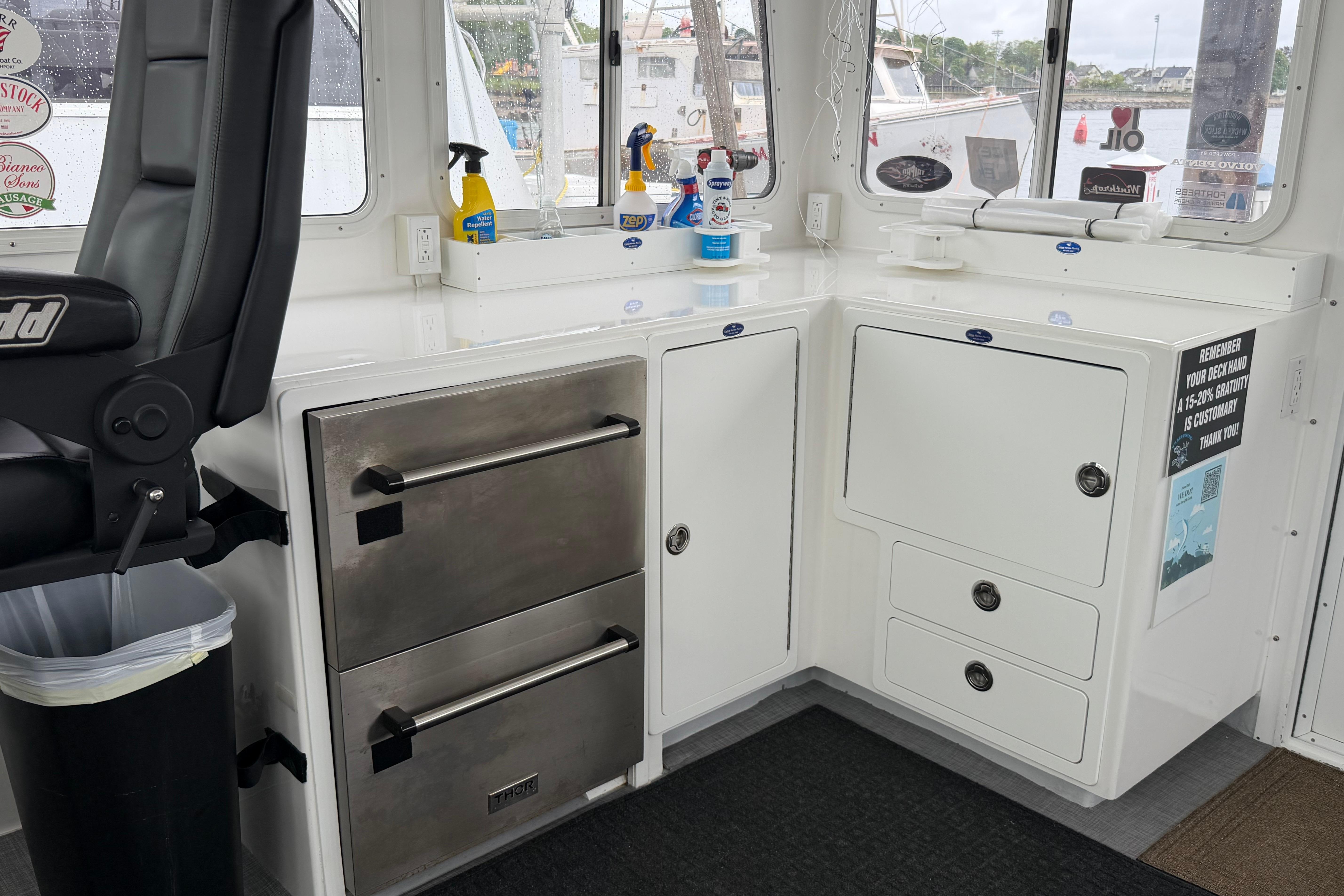 Interior of a 2018 H&H Marine Osmond Beal boat with storage and cleaning supplies.