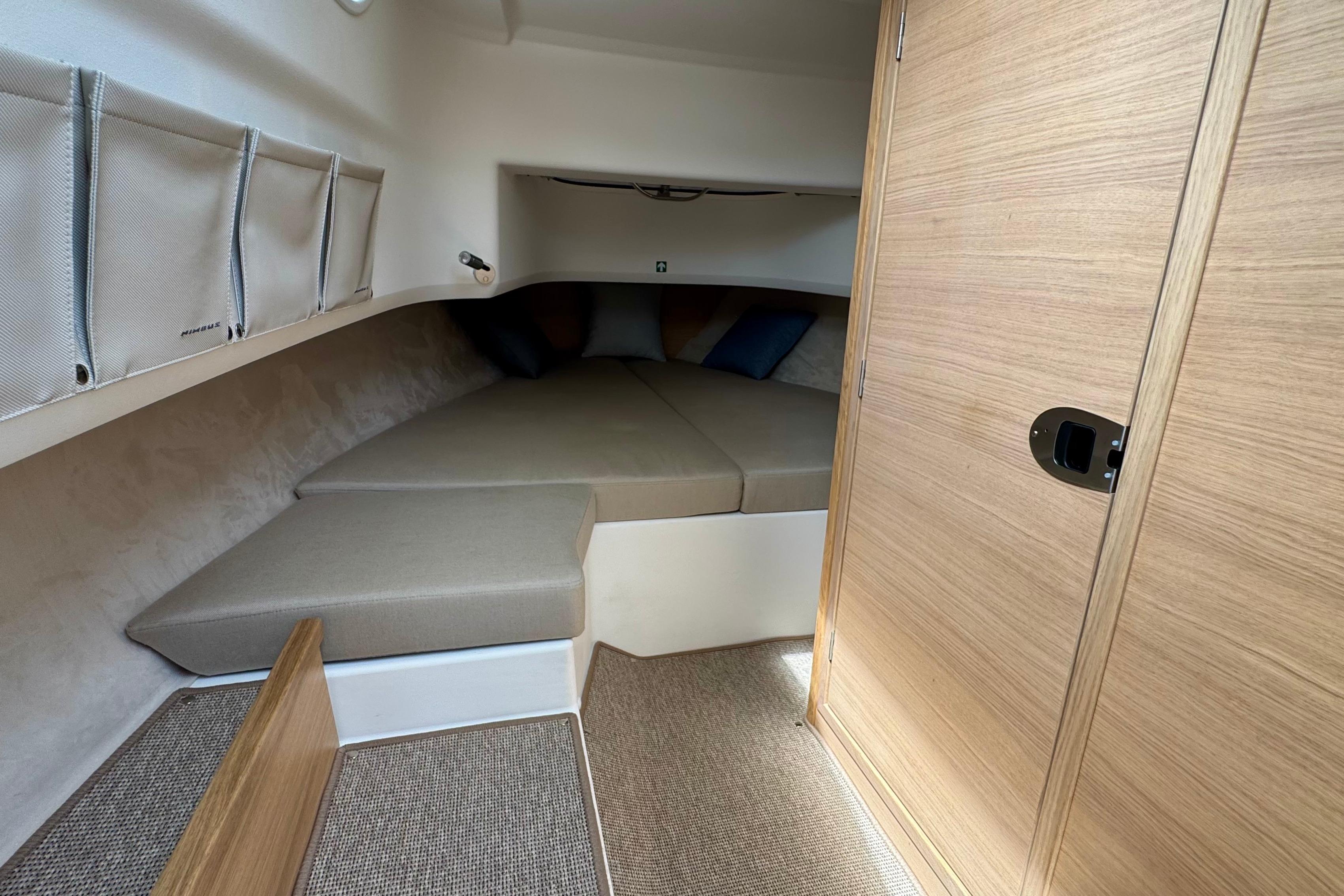 Interior of the Nimbus Commuter 9 with a cozy sleeping cabin and wooden door.