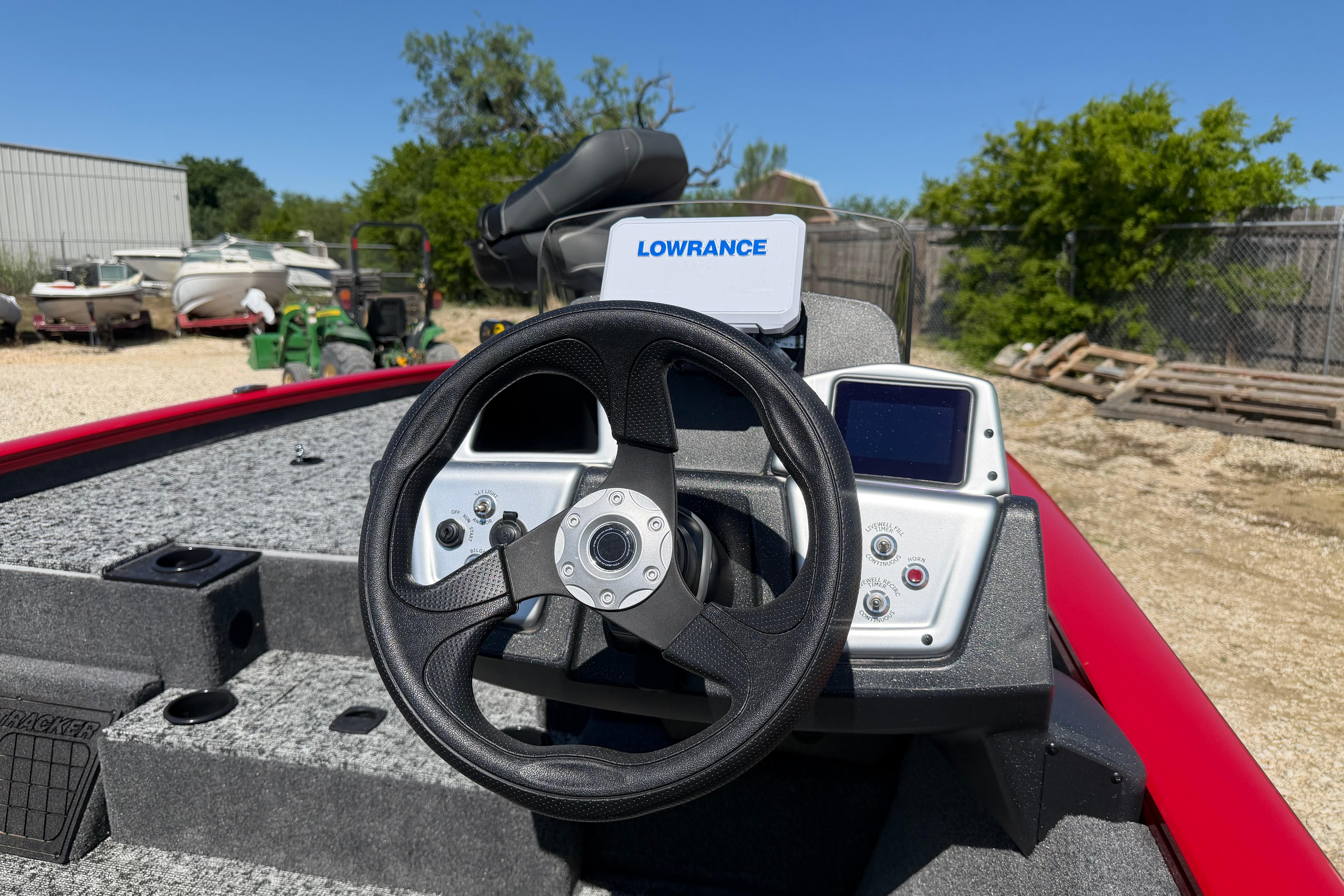 2026 Tracker Pro Team 195 boat dashboard with steering wheel and Lowrance navigation system.