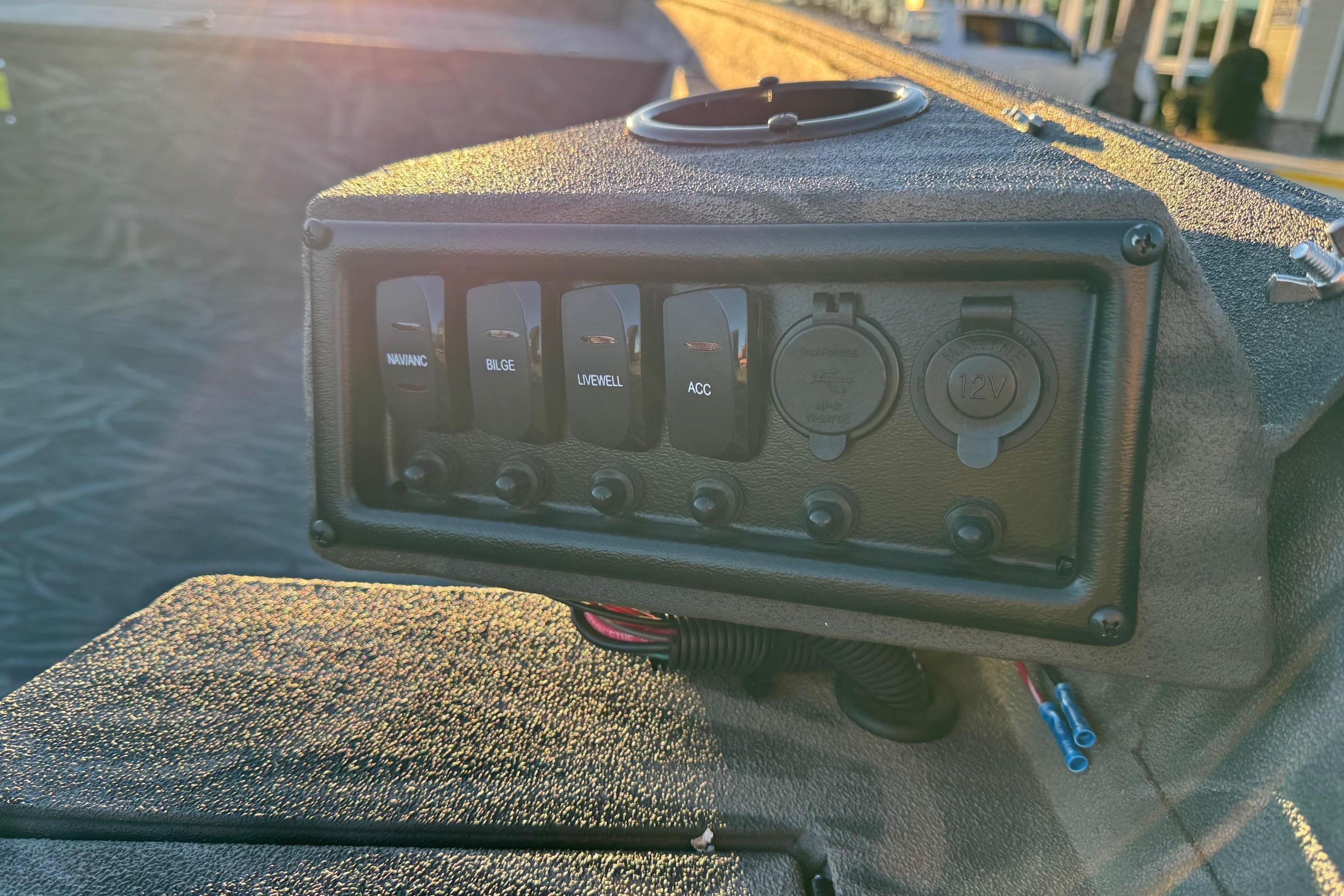 Control panel of 2026 Alweld 1652 Invader boat with switches and outlets.