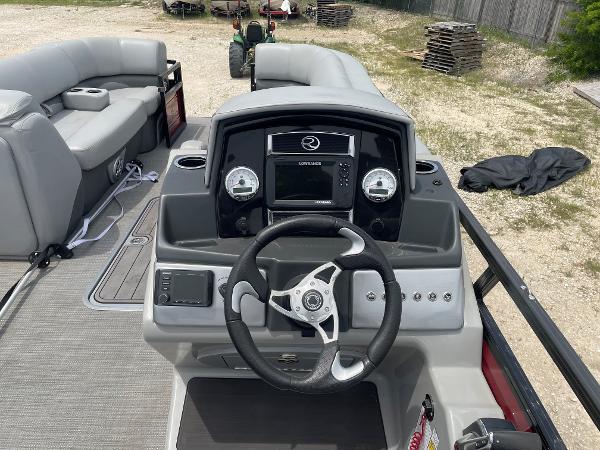 2023 Regency 250DL3 boat dashboard with steering wheel and navigation system.