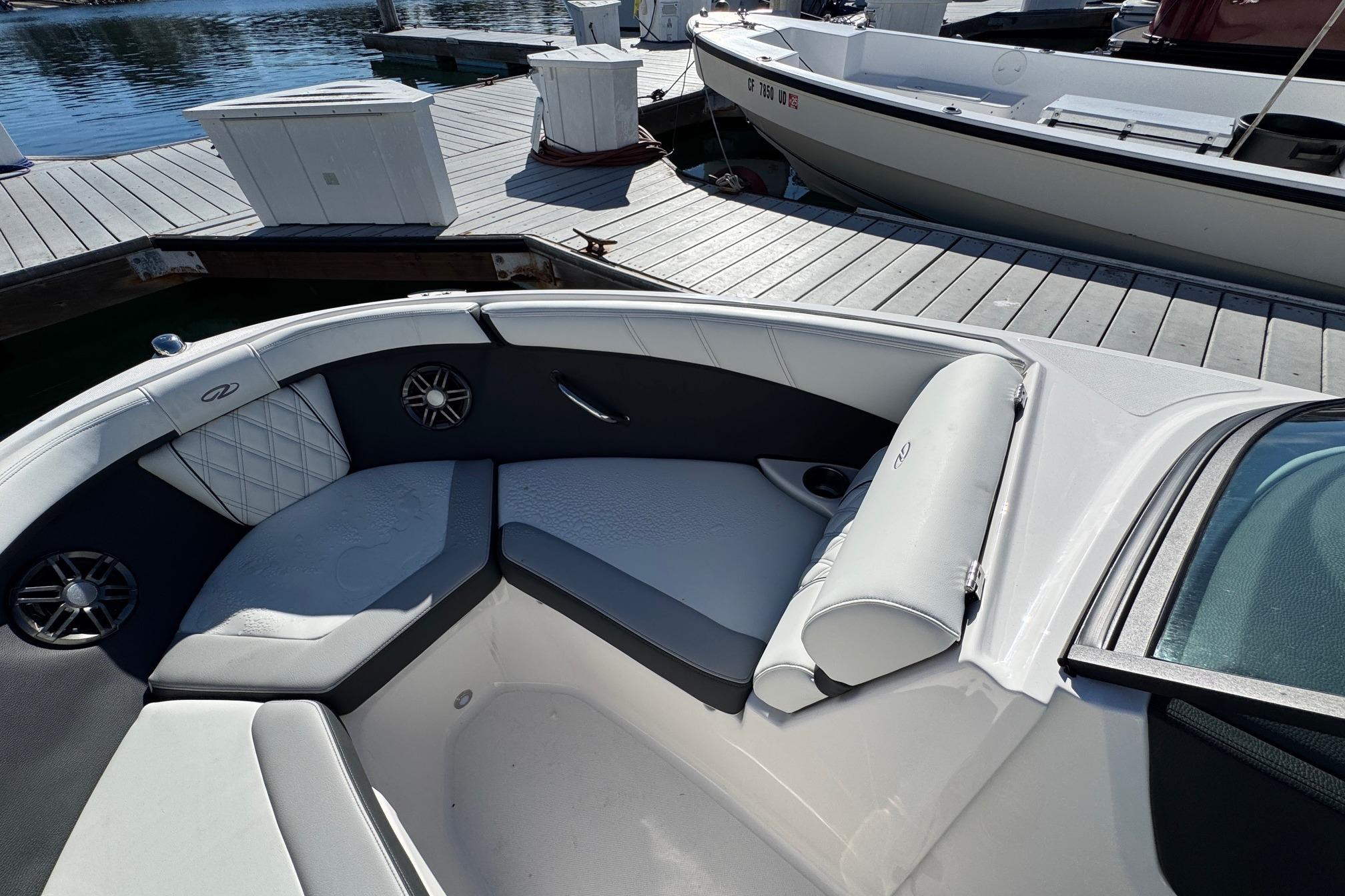2026 Regal 21 OBX boat interior with cushioned seating at a dock.
