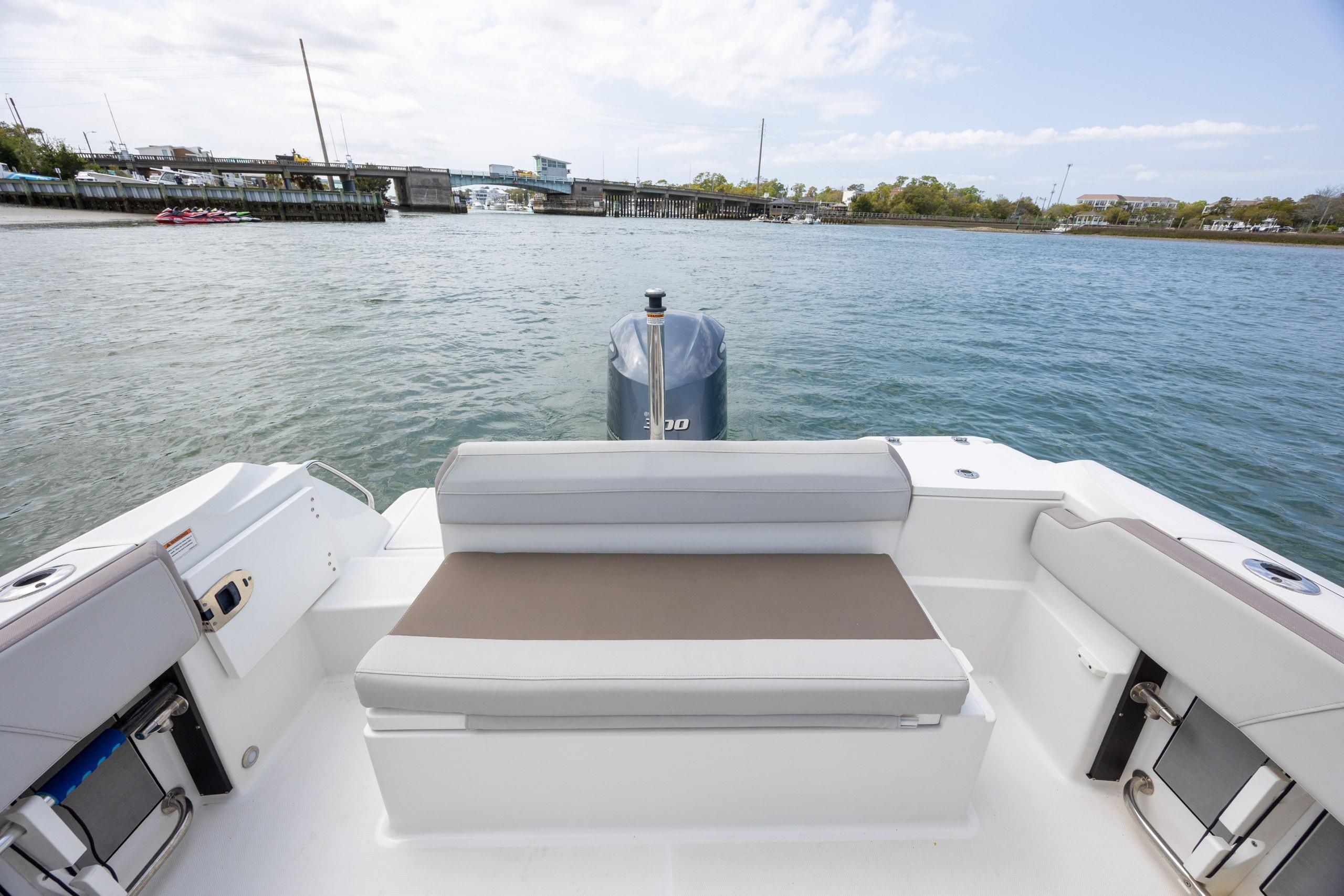 2019 Blackfin 212 CC boat interior with seating, overlooking calm waters and distant shoreline.