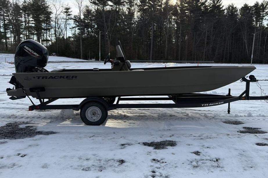 2026 Tracker Grizzly 2072 CC boat on trailer in snowy landscape.