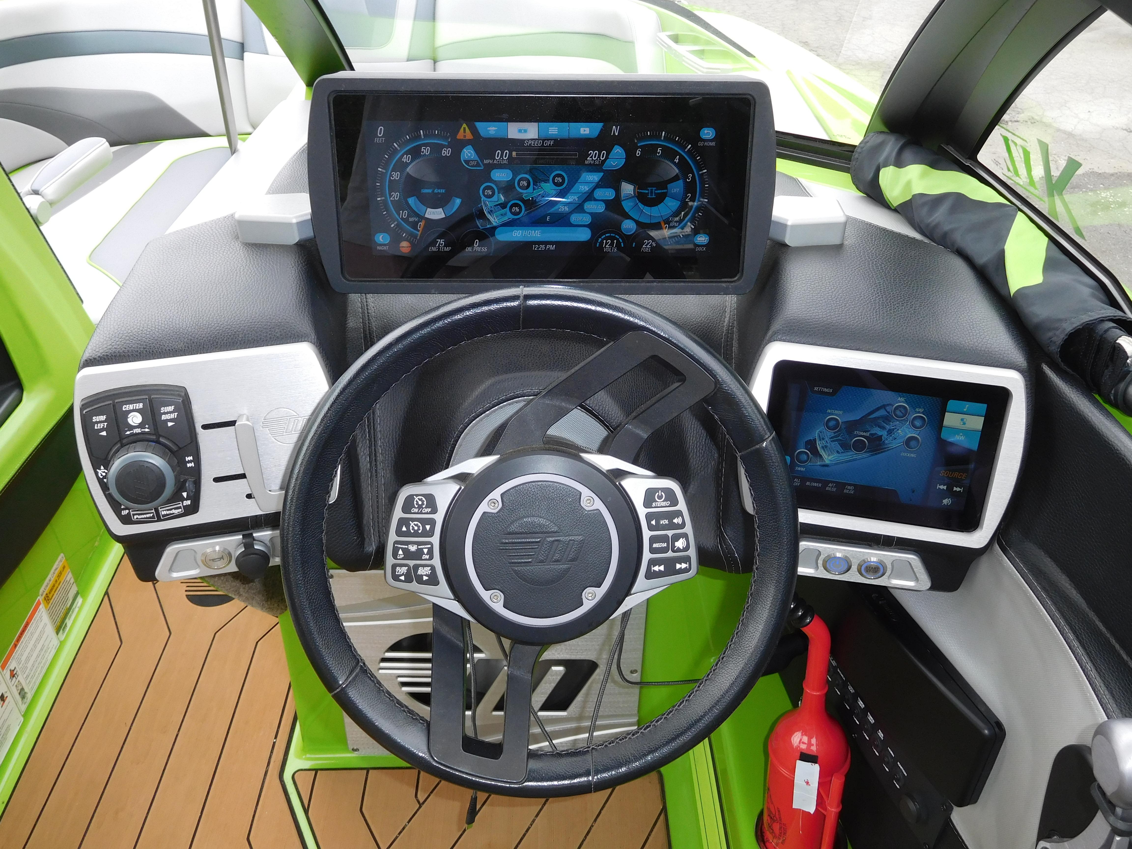 2017 Malibu Wakesetter 24 MXZ boat dashboard with steering wheel and digital displays.