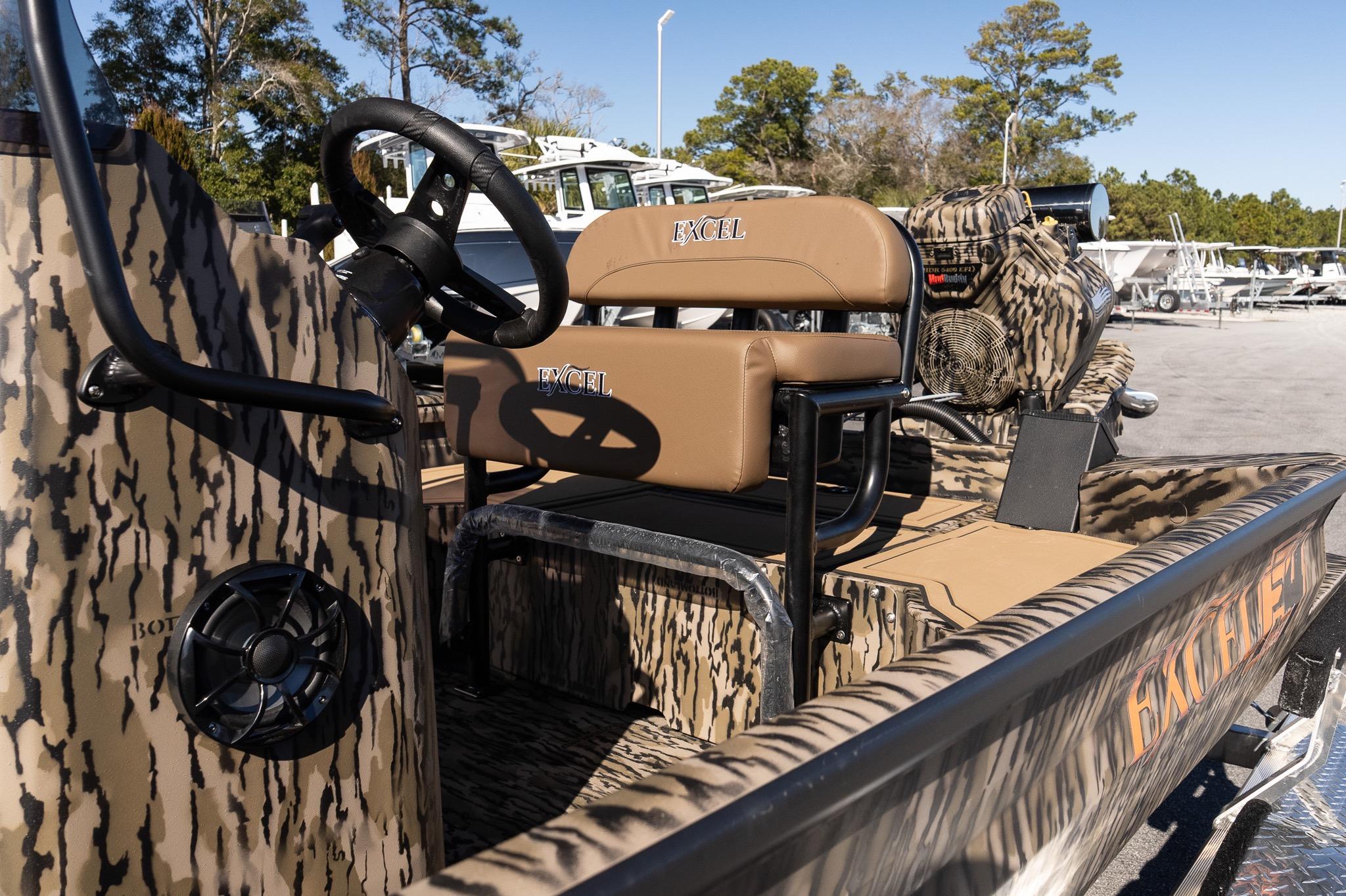 2026 Excel 1860 Shallow Water F4 CC boat with camo design and tan seating.