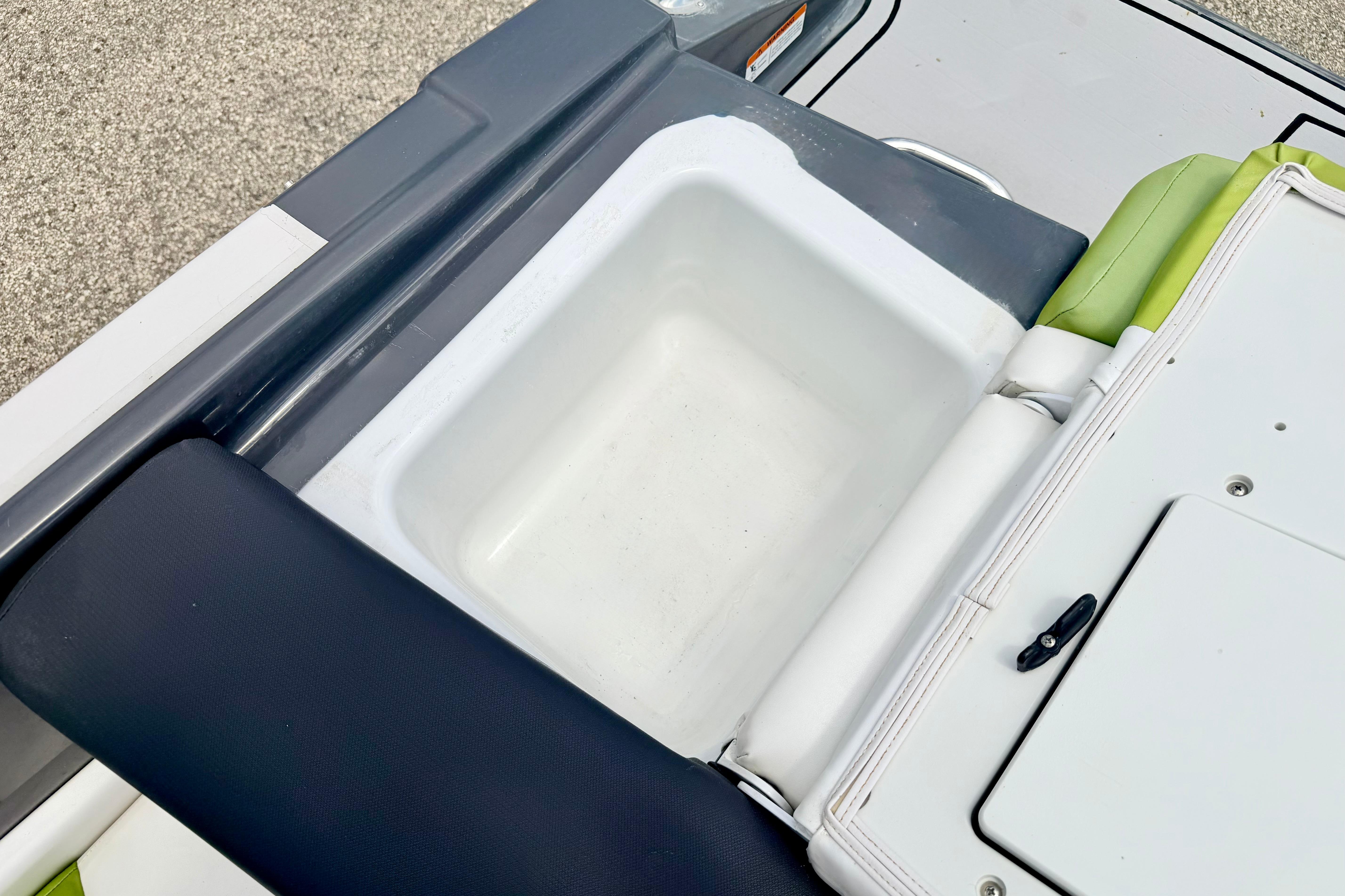 2018 Glastron GT 185 boat interior with storage compartment and cushioned seating.