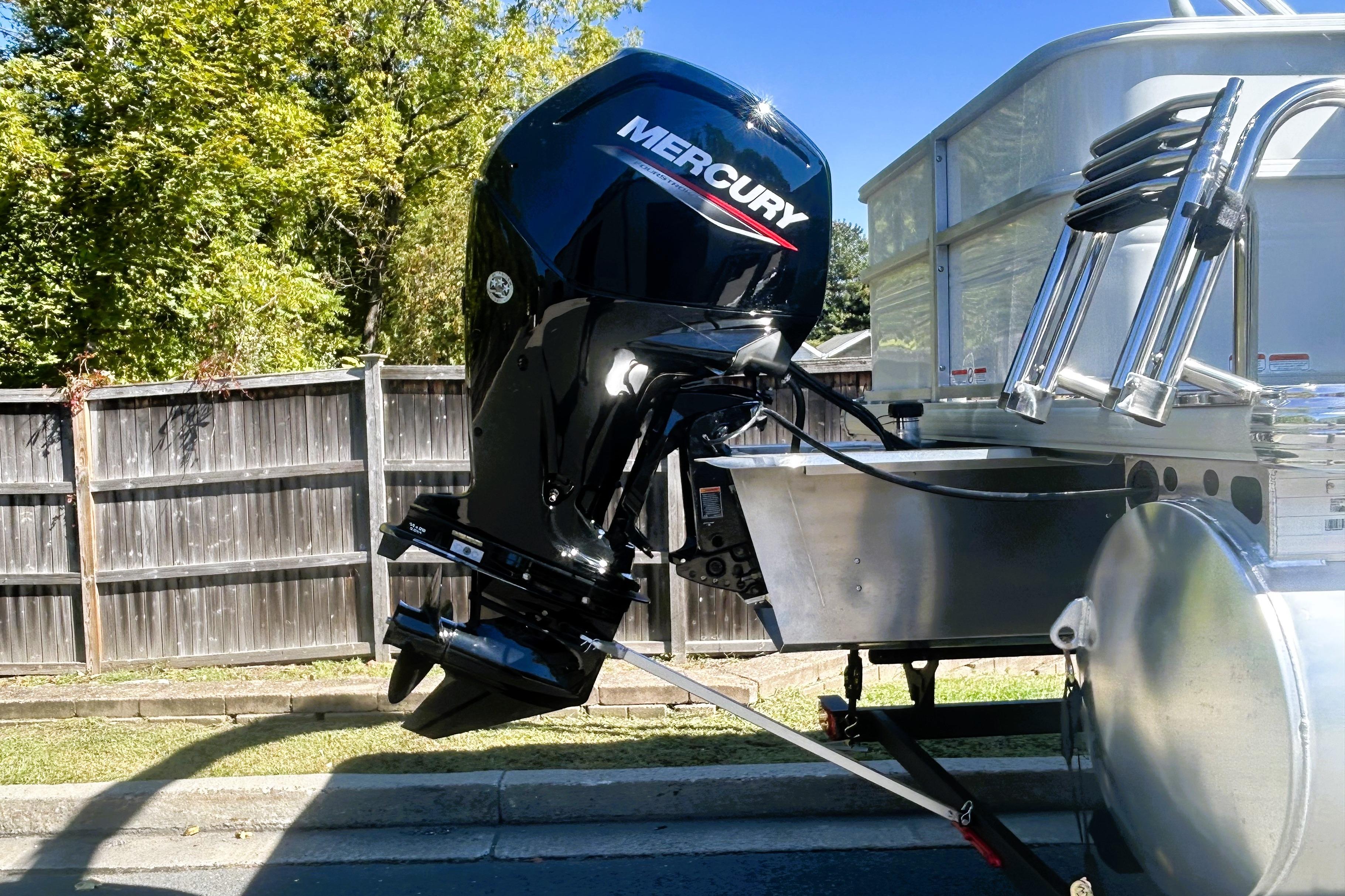 2026 Sun Tracker Party Barge 18 DLX with Mercury outboard motor, parked outdoors.