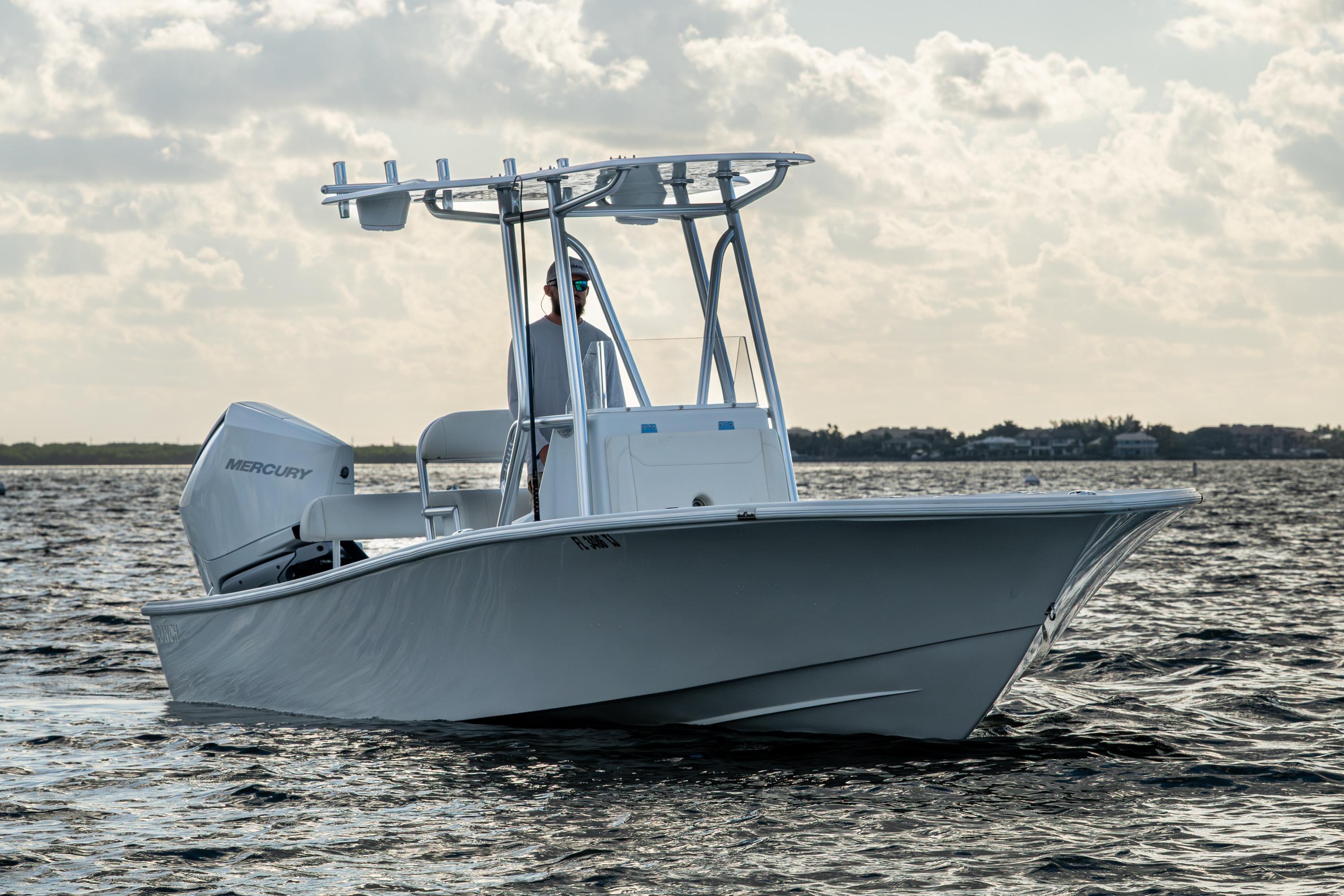 2022 Conch 25 boat on water with Mercury engine, under cloudy sky.