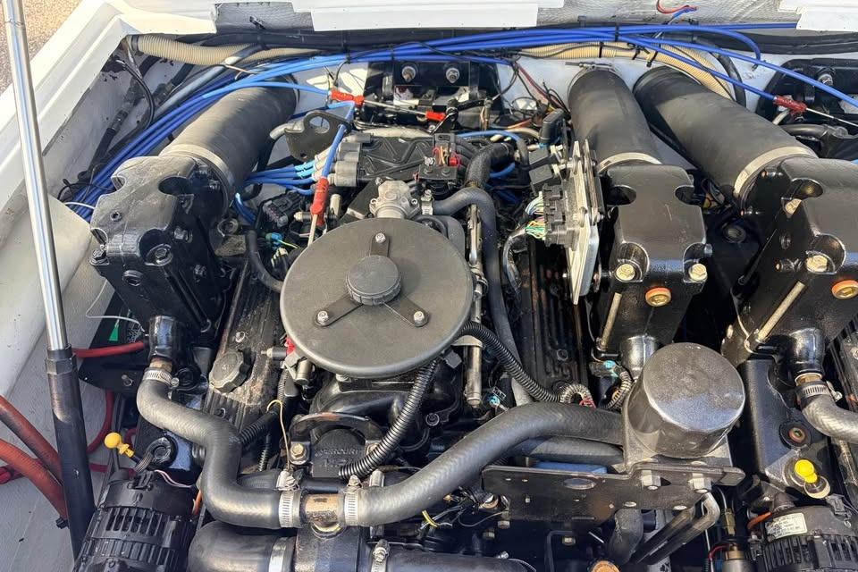 Engine of a 1983 Cigarette 24' Classic boat, showcasing intricate mechanical components.