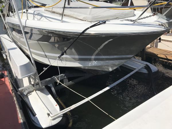 2017 Jeanneau NC 11 boat docked on a lift in a marina.