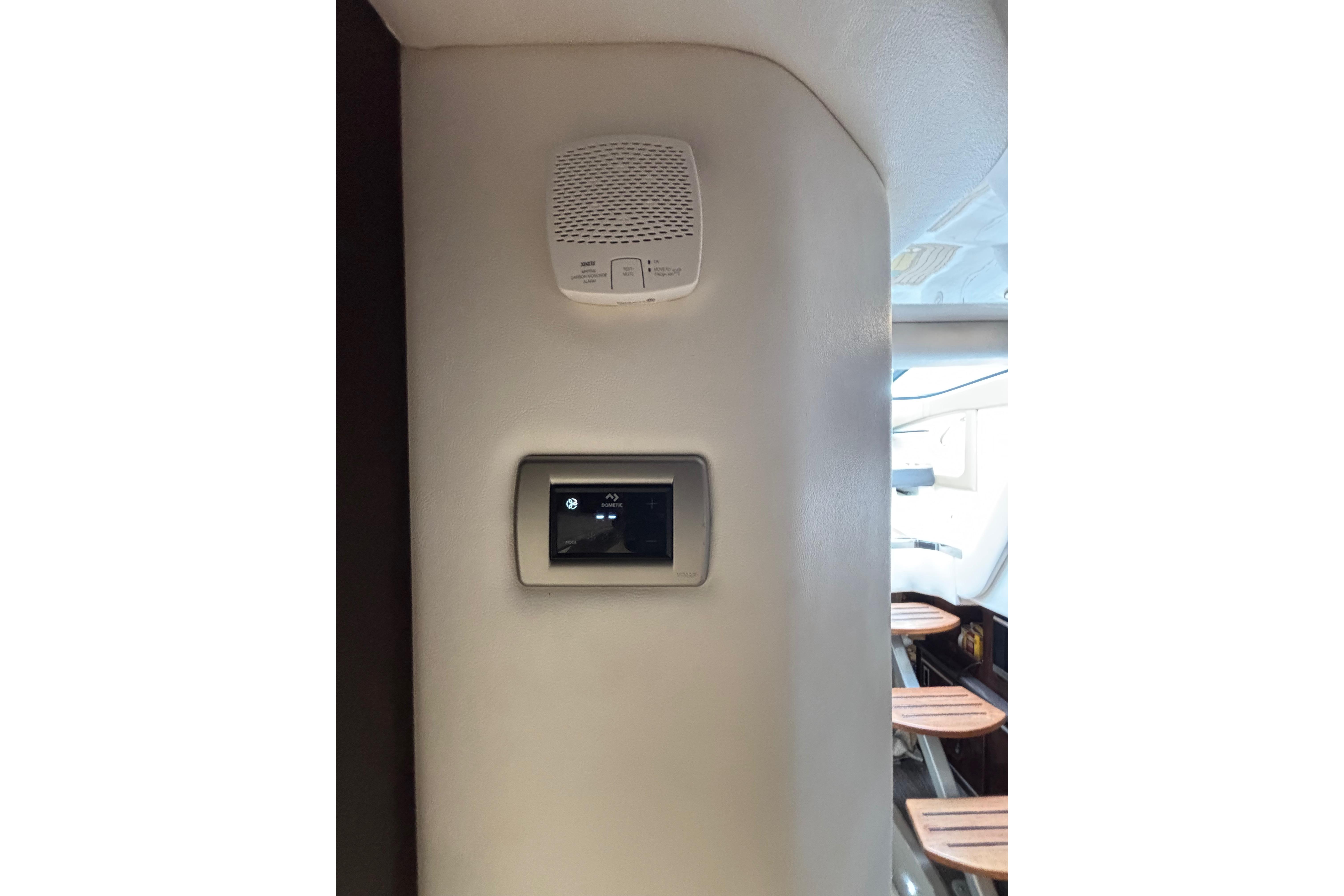 Interior of 2021 Sea Ray Sundancer 320 Outboard with control panel and speaker.