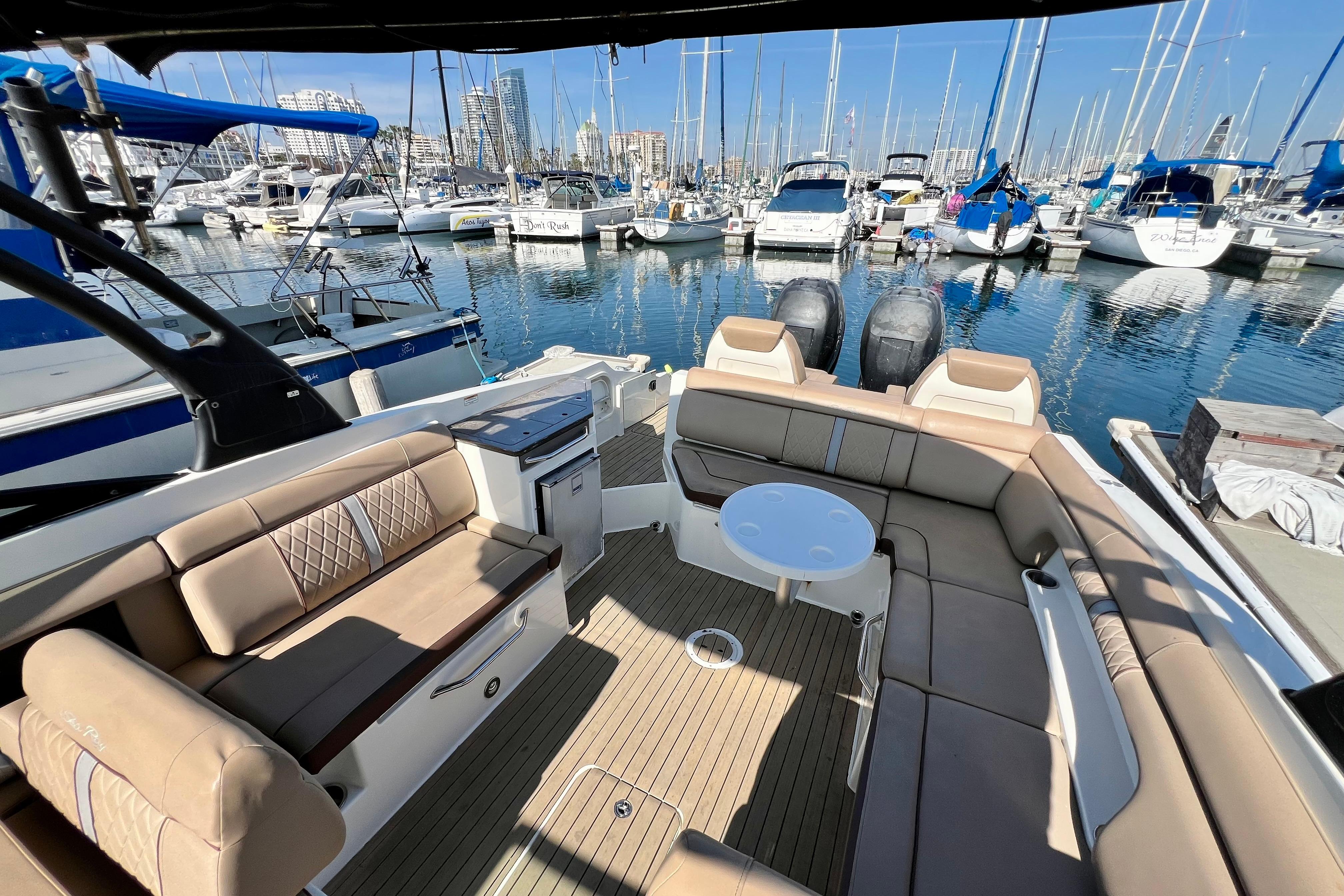 2016 Sea Ray 290 Sundeck Outboard at marina, featuring spacious seating and elegant design.