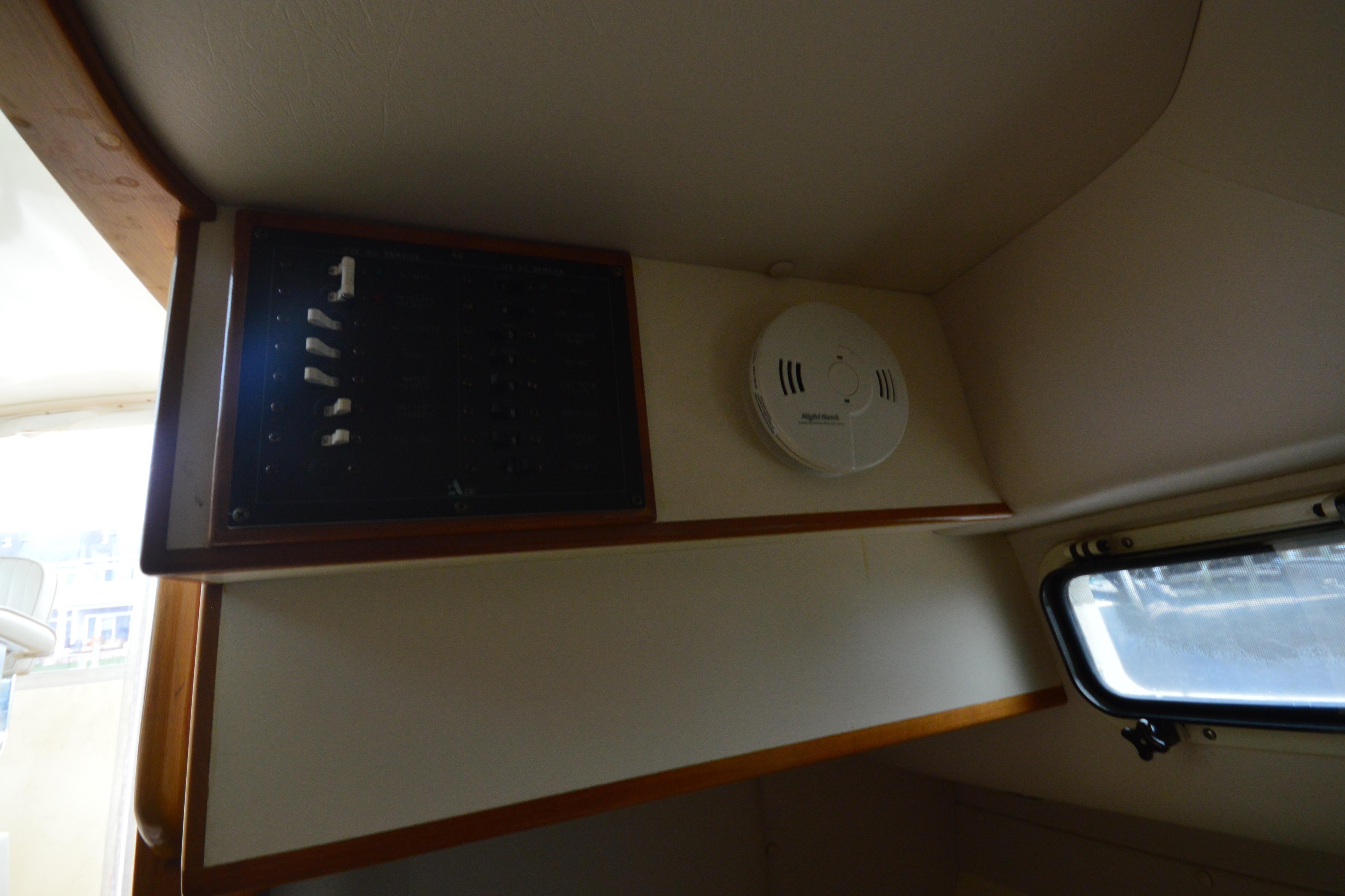 Interior of 2001 Albin 28 Tournament Express with control panel and smoke detector.