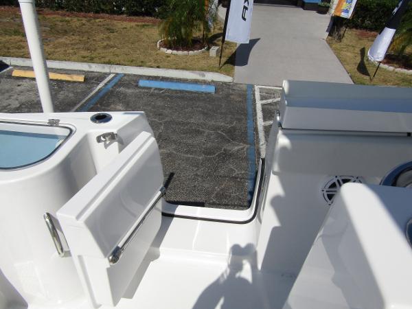 2024 Wellcraft 263 Fisherman boat deck with open door and parking lot view.