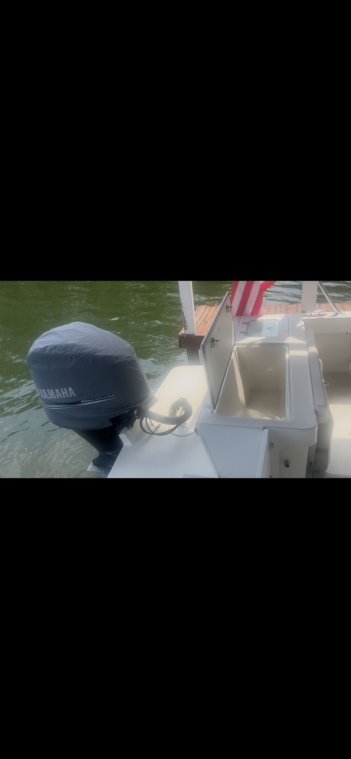 A Parker 2320 Sport Cabin boat with an outboard motor at the dock.
