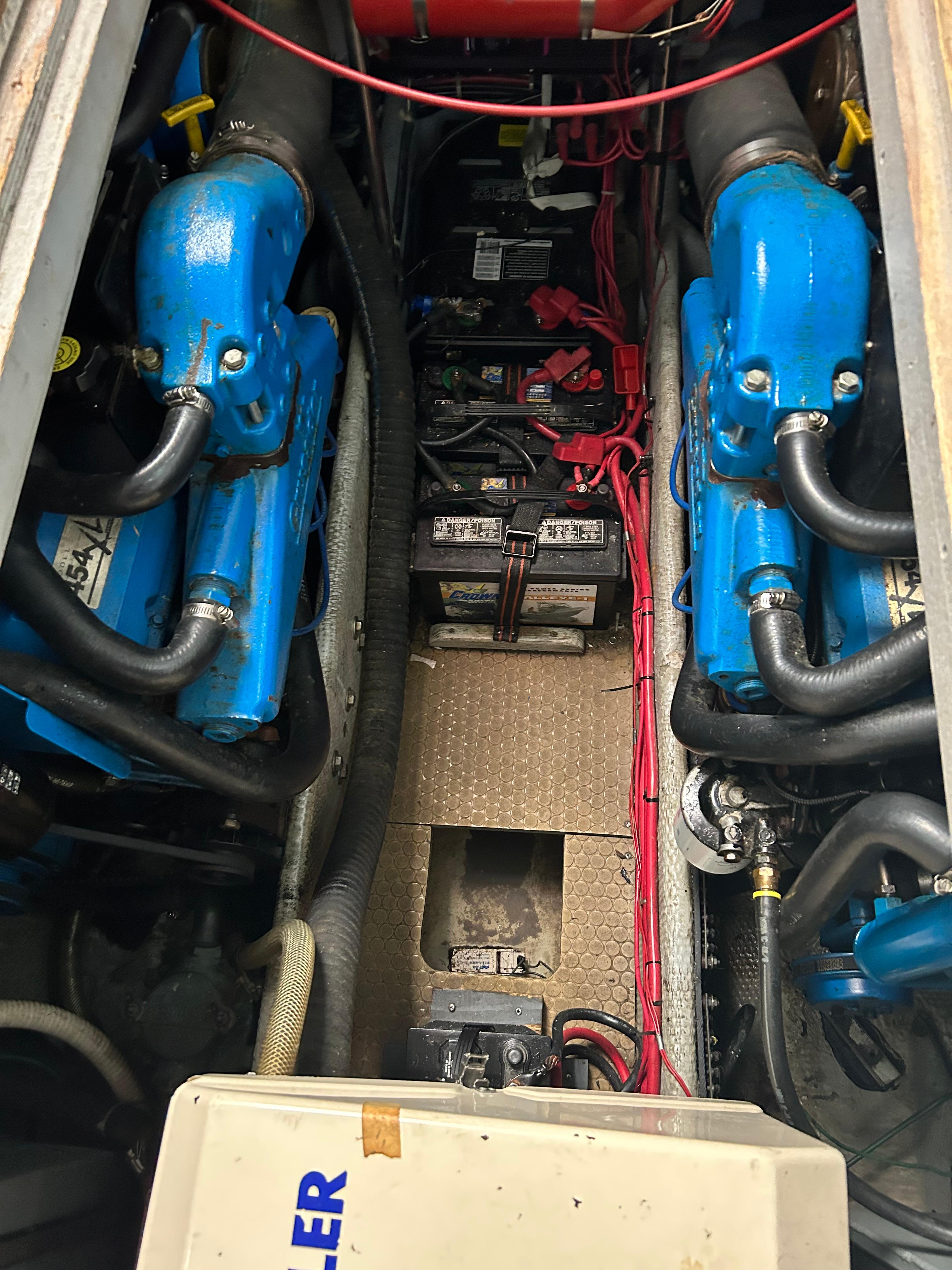 Engine compartment of a 1995 Silverton AFT CABIN boat with dual blue engines.