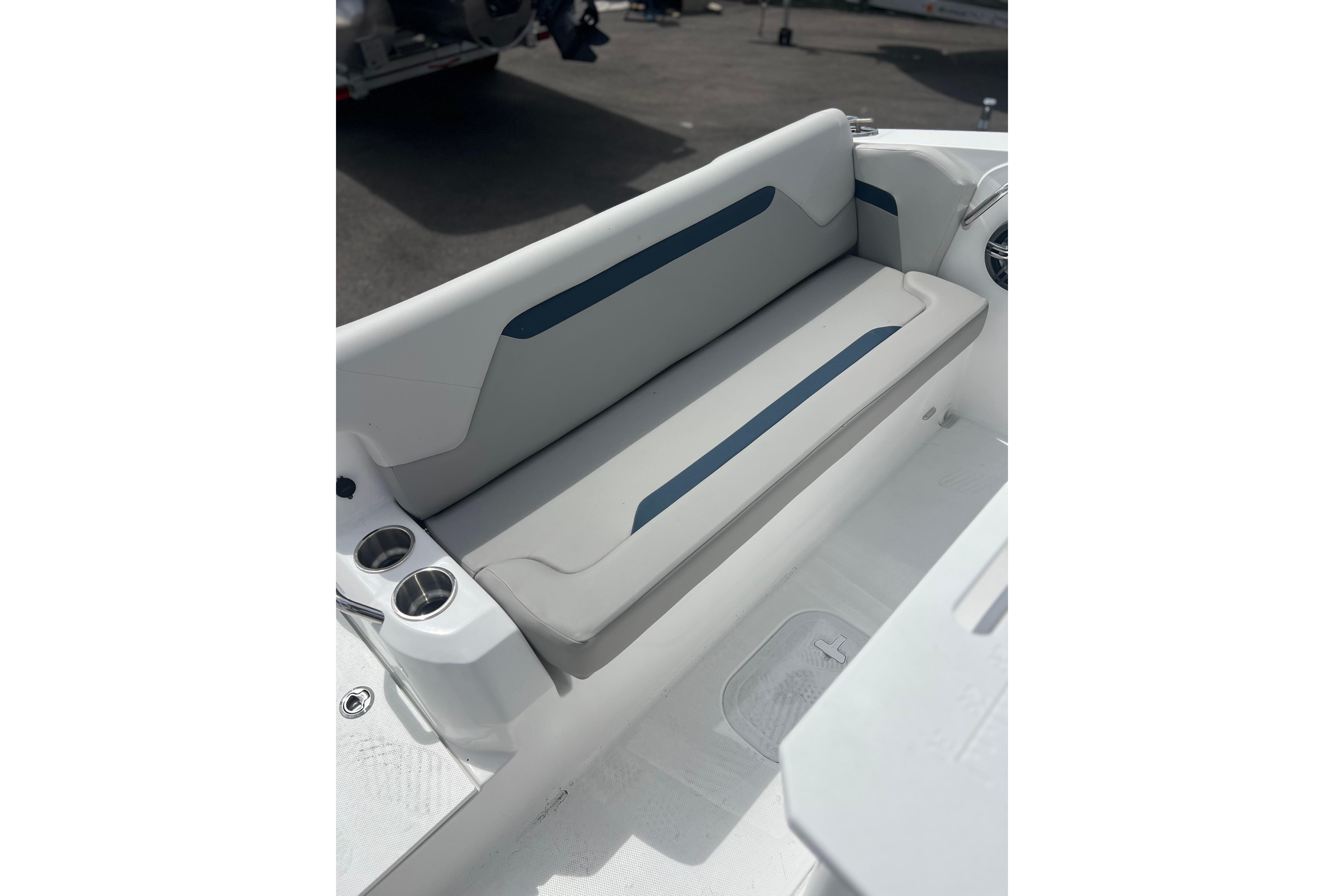 2025 Hurricane Center Console 24 OB boat interior with cushioned seating and cup holders.
