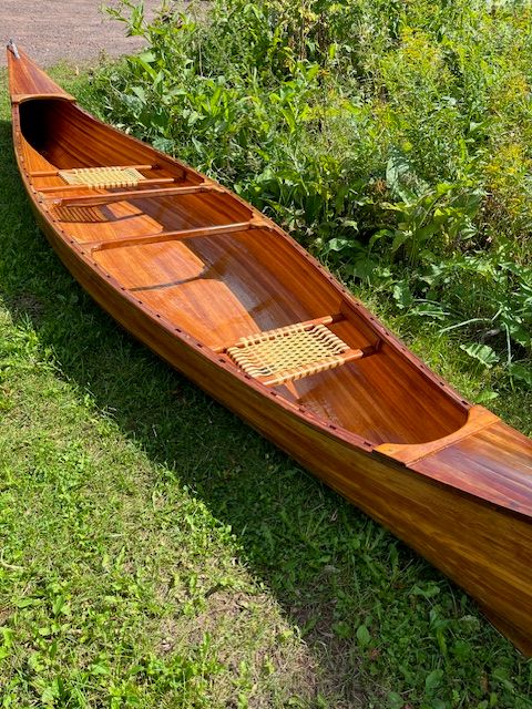 Cedar strip canoe on grass