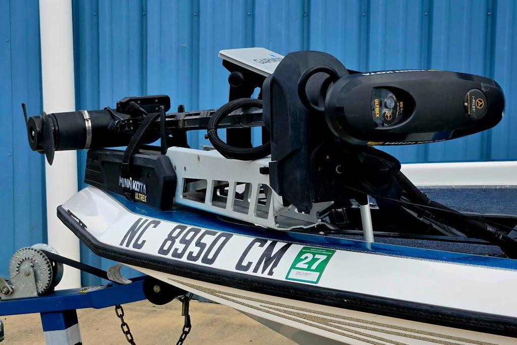1996 Champion 181 SX boat with Minn Kota Ultrex motor, blue background.