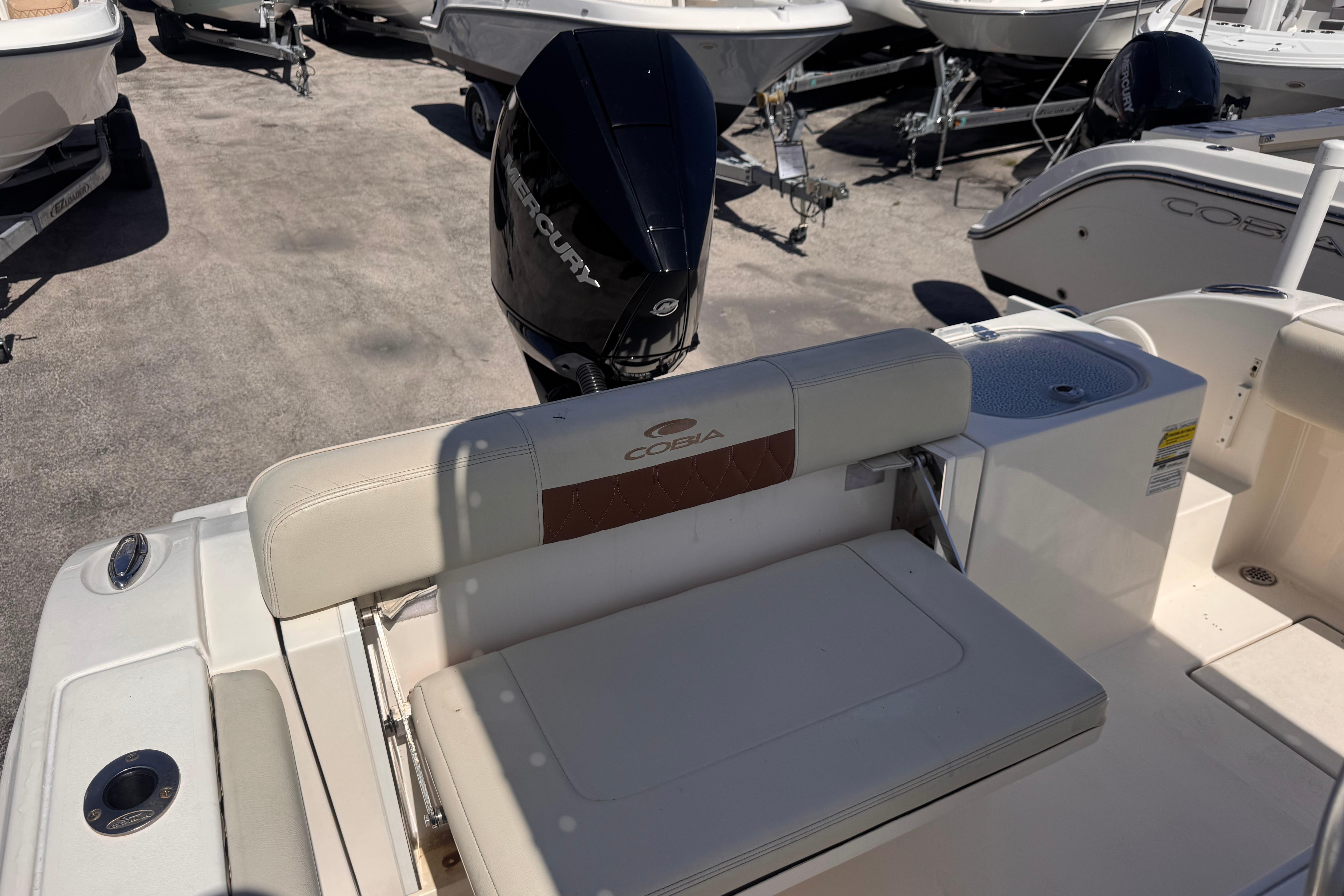 2023 Cobia 237 Center Console boat with Mercury engine, featuring comfortable seating.