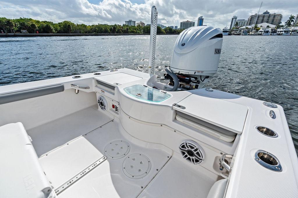 2023 Everglades 243 Center Console boat with Yamaha engine on calm water.