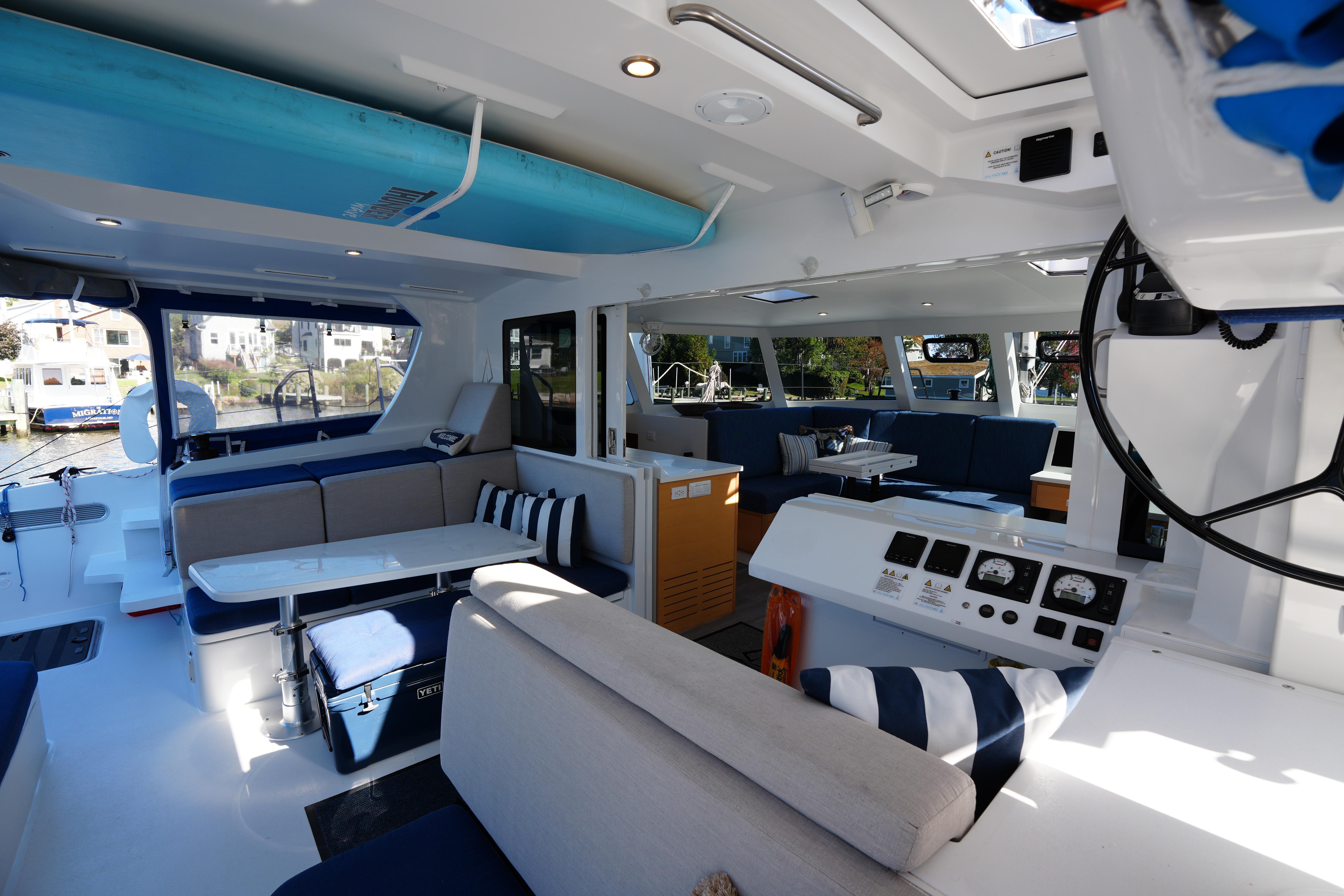 Luxurious interior of 2024 Balance 442 catamaran with modern seating and navigation equipment.