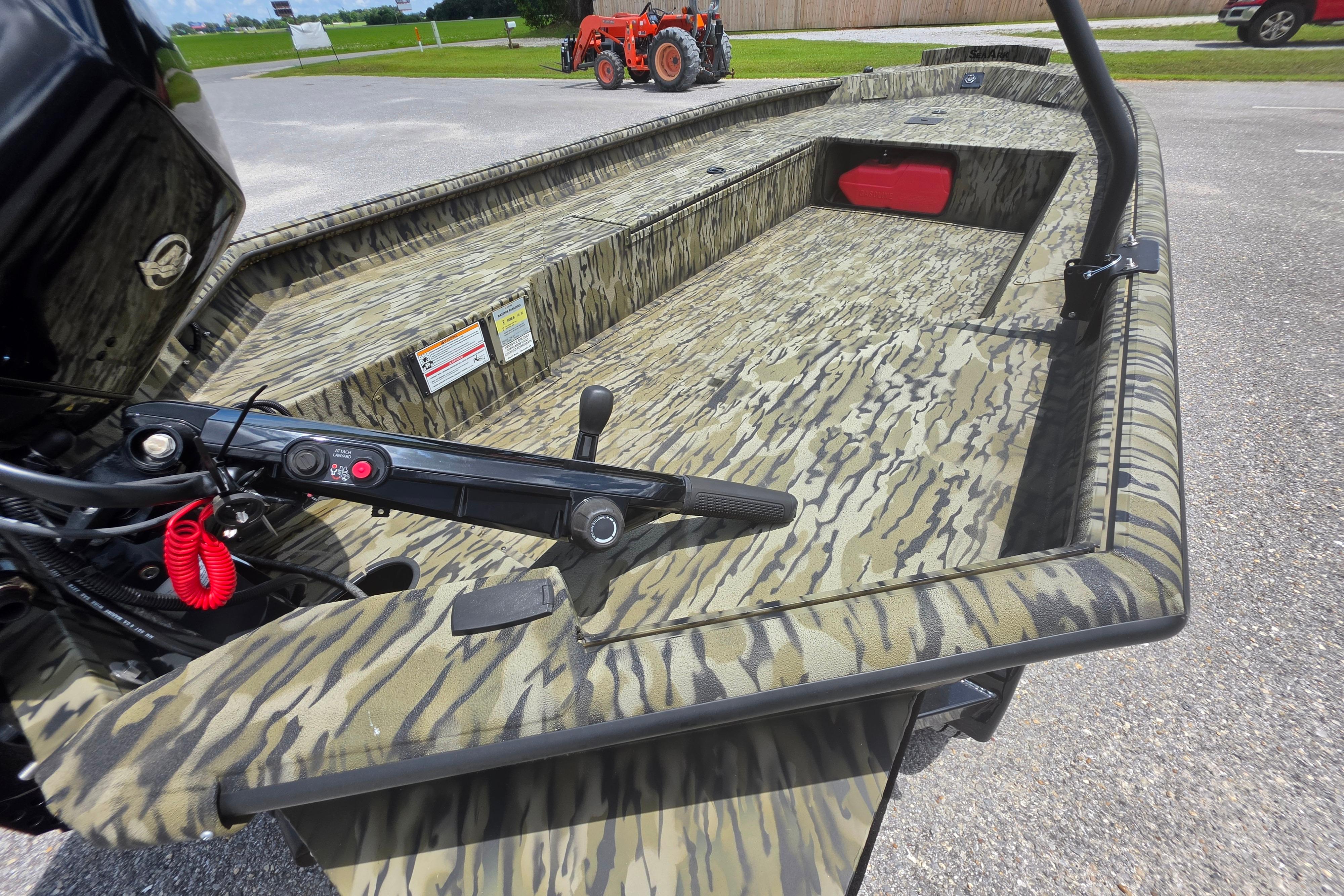 2025 SeaArk 1752 Slayer boat with camouflage design, featuring a spacious interior and modern controls.